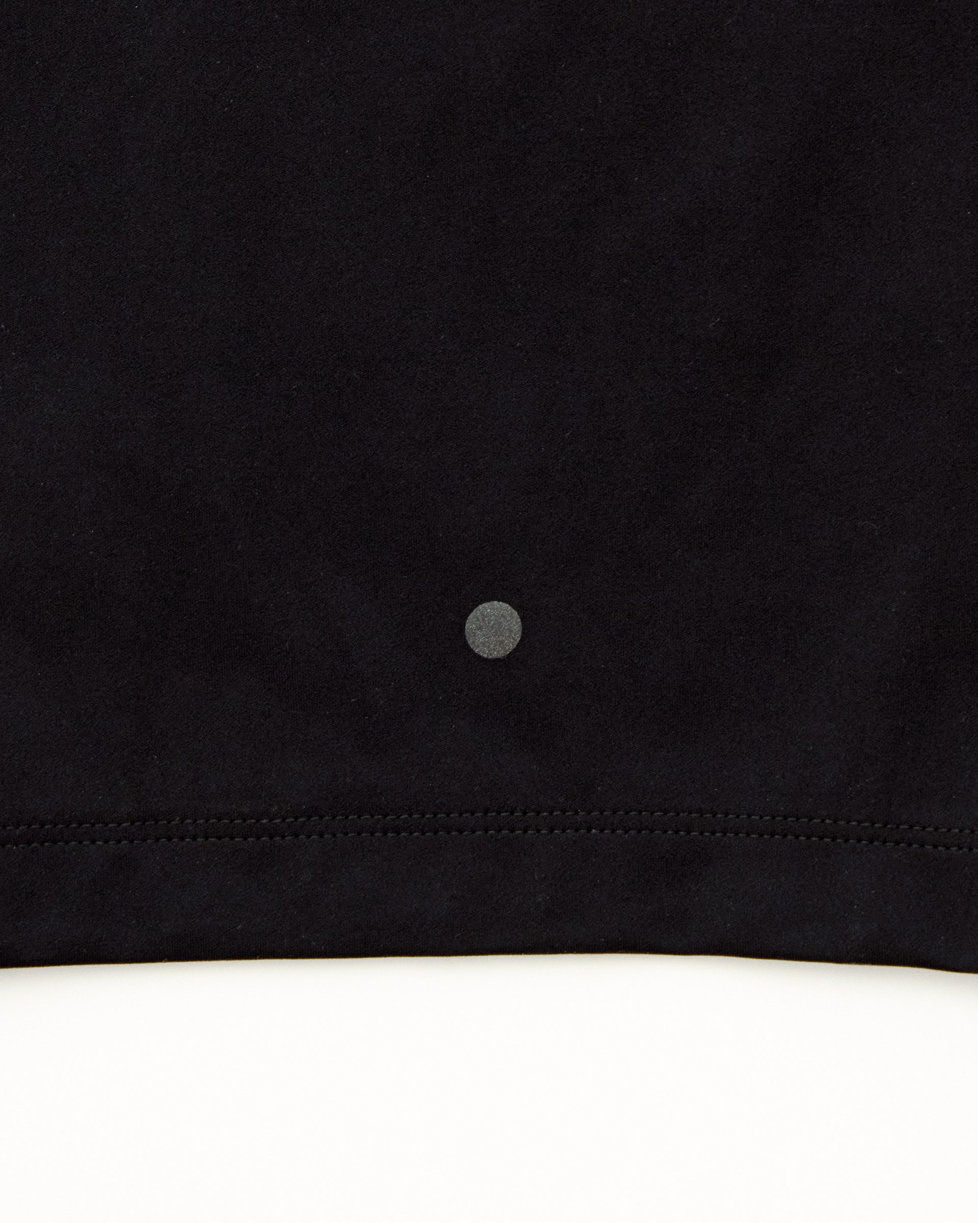 Dark Olive Balance short tights, detail view with contrast stitching and reflective logo