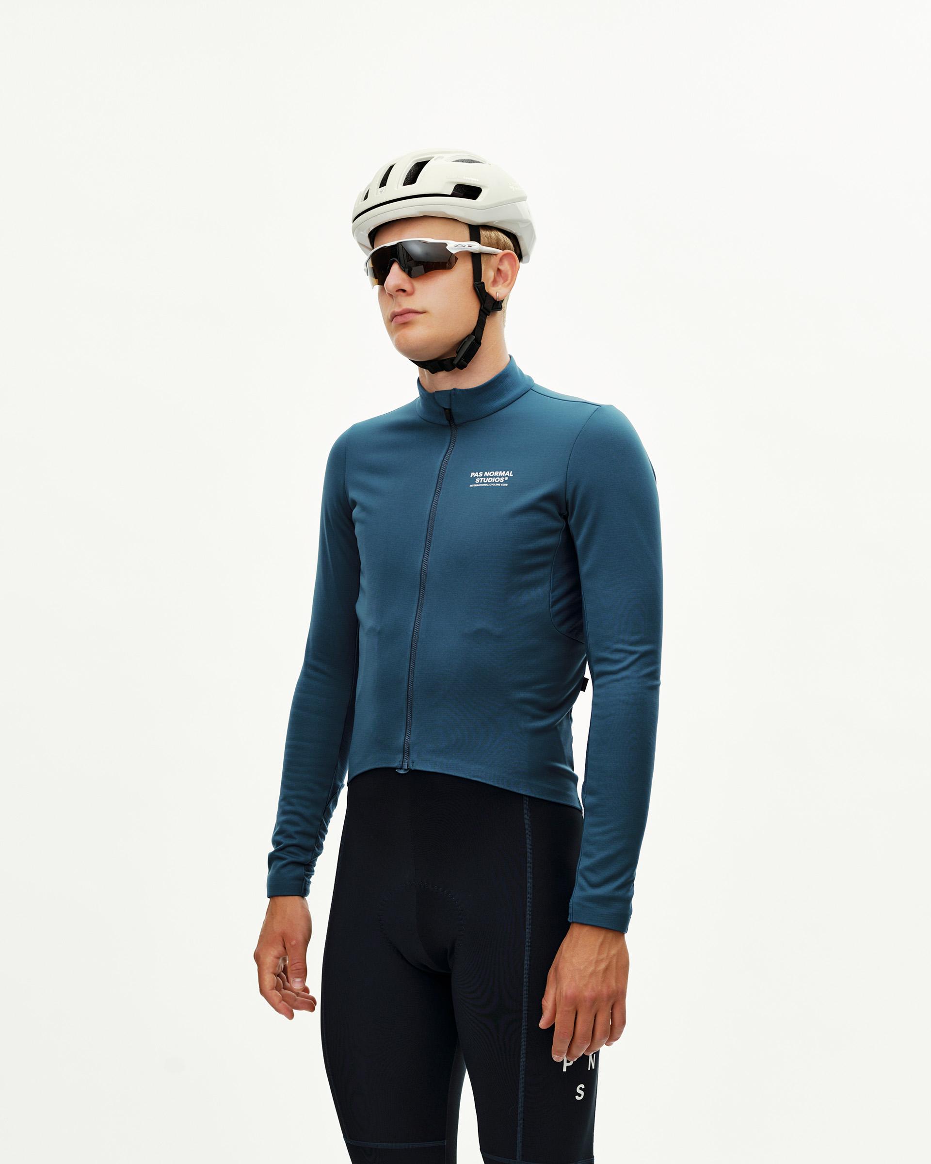 Denim Blue Mechanism Thermal Long Sleeve cycling jersey on model, front three-quarter view with white chest logo