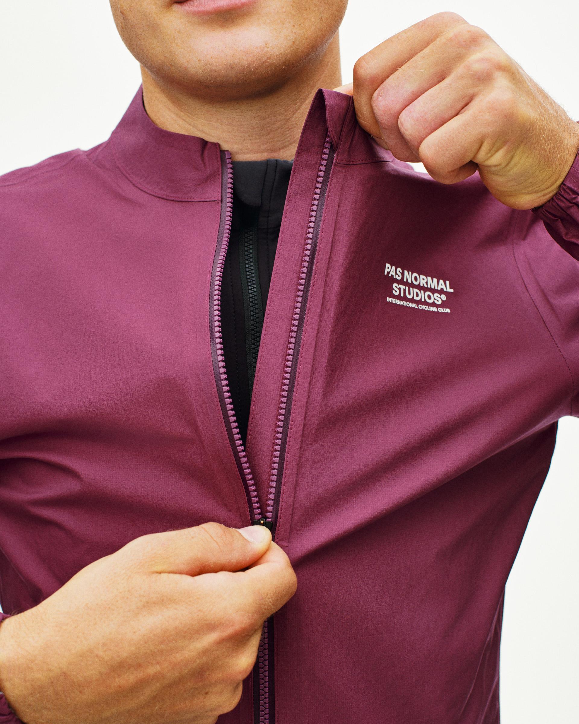 Purple Mechanism Rain cycling jacket on model with full zip and white chest logo