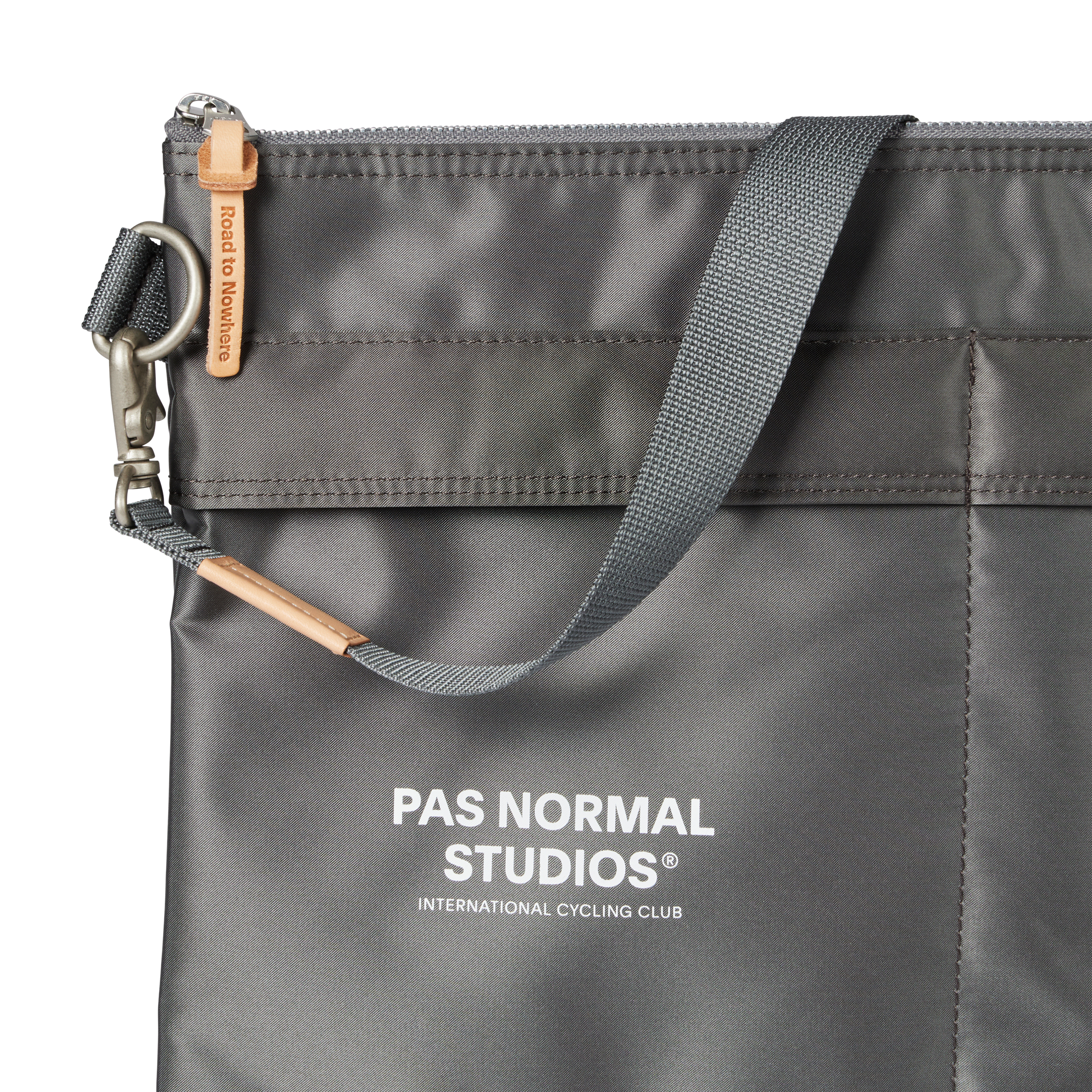 Grey Porter-Yoshida musette, front detail view with tan leather zip pull and metal clip hardware