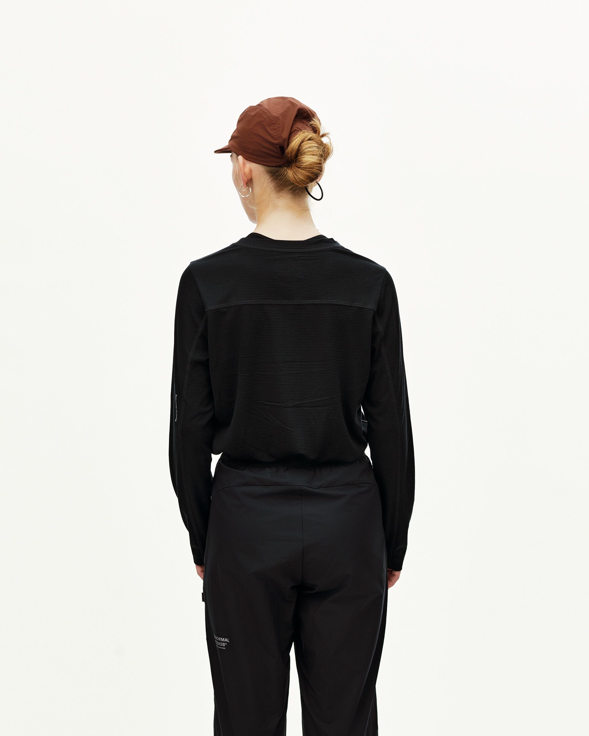 Black Balance Performance Pants on model, rear view with seam detailing