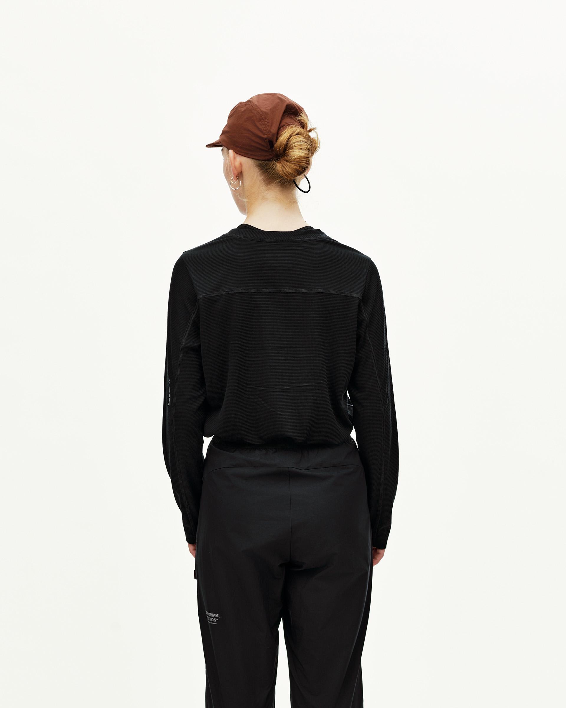 Black Balance Performance Pants on model, rear view with seam detailing