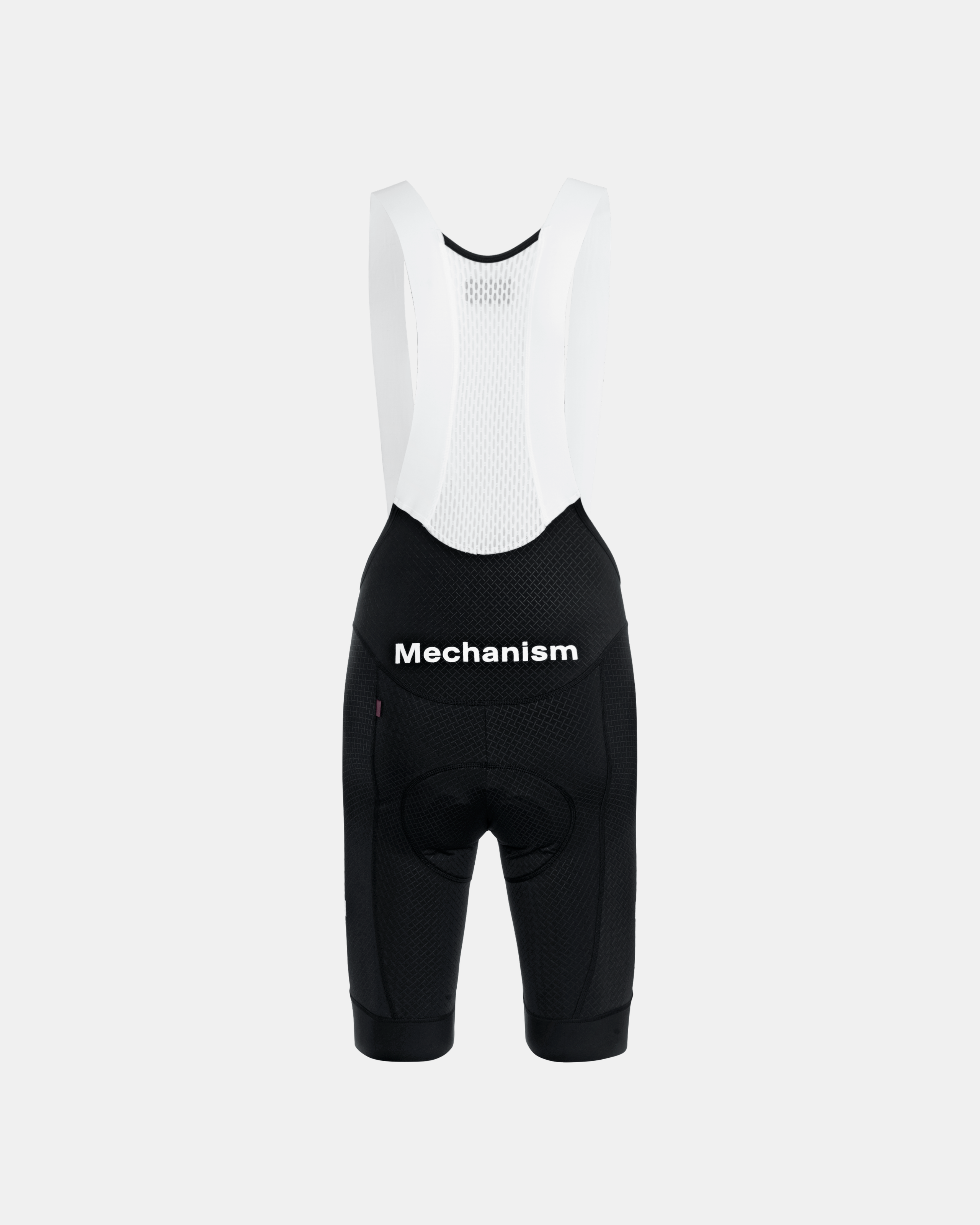 Black Mechanism cycling bibs, front flat lay with white mesh bib and black contrast text