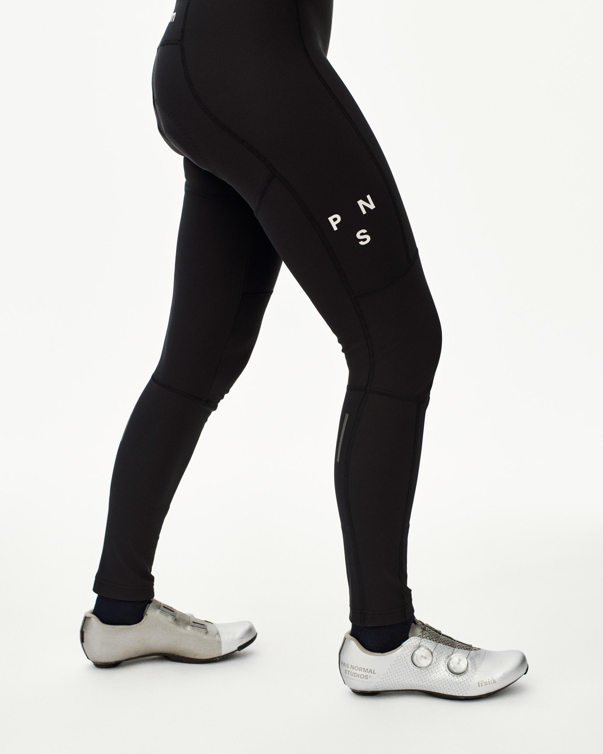 Black Mechanism Deep Winter Long bibs on model with white leg branding and ankle cuffs