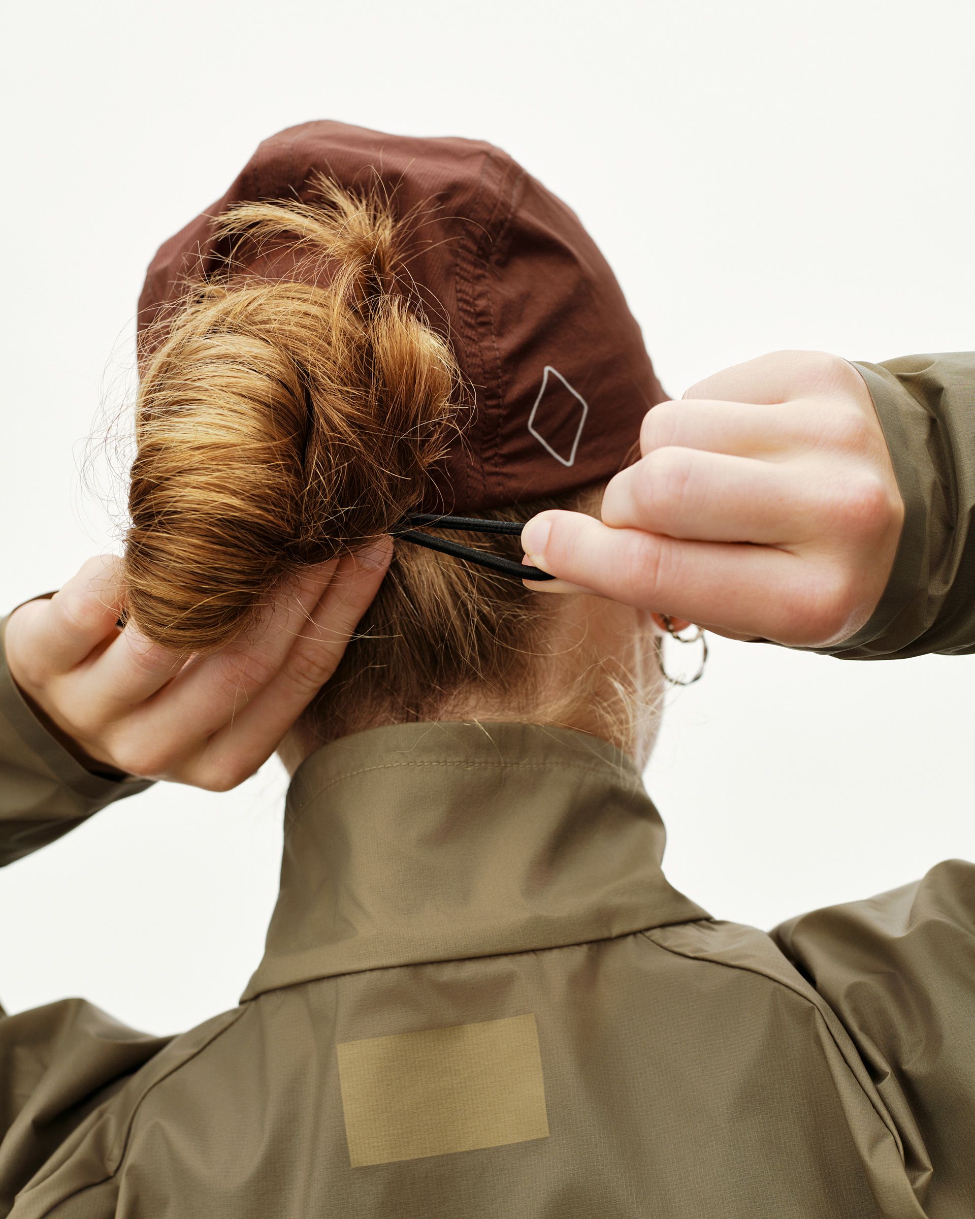 Maroon Brown Balance Cap on model, rear view with diamond logo detail