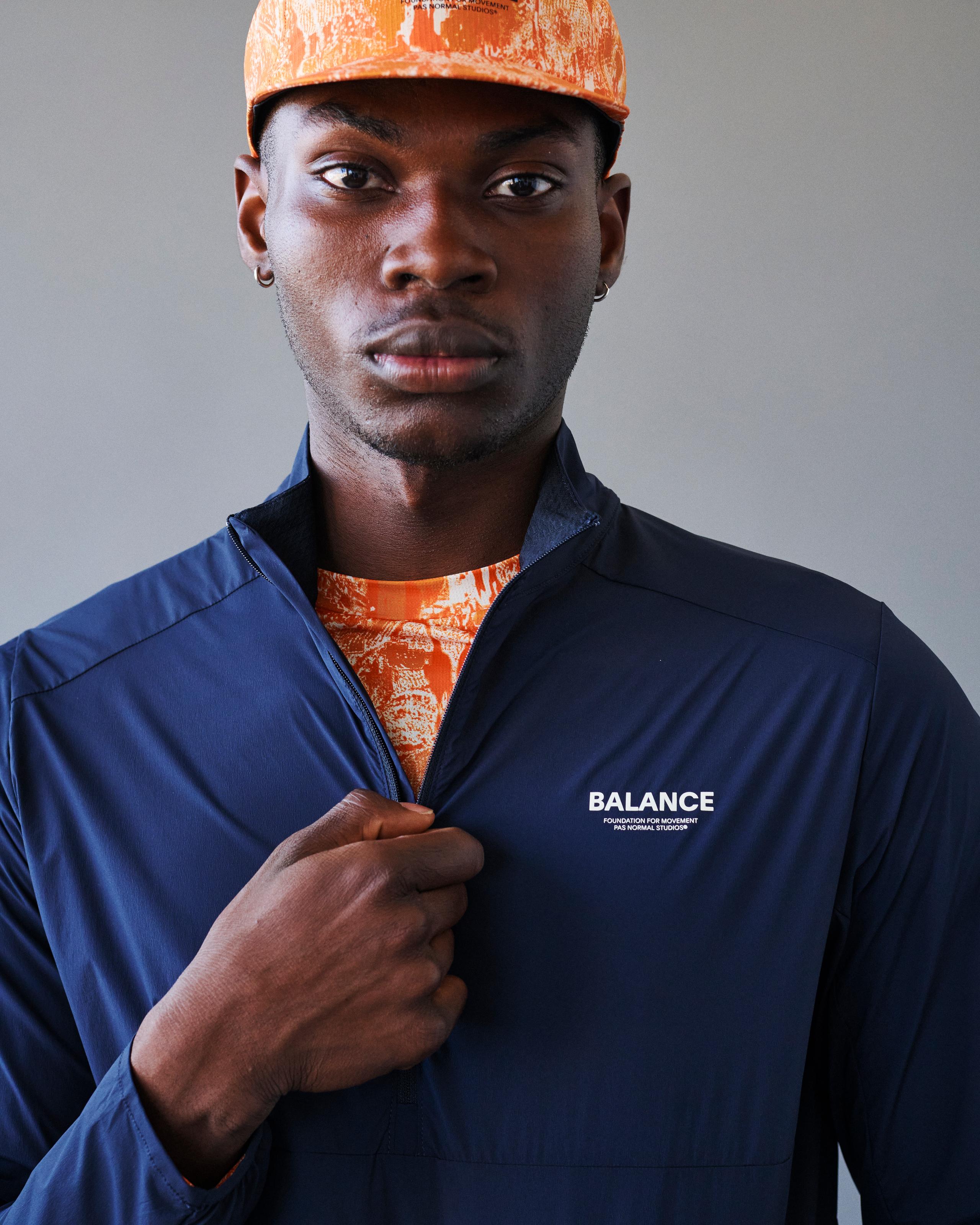 Navy Balance Half Zip jacket on model, front view with white chest logo and half zip open