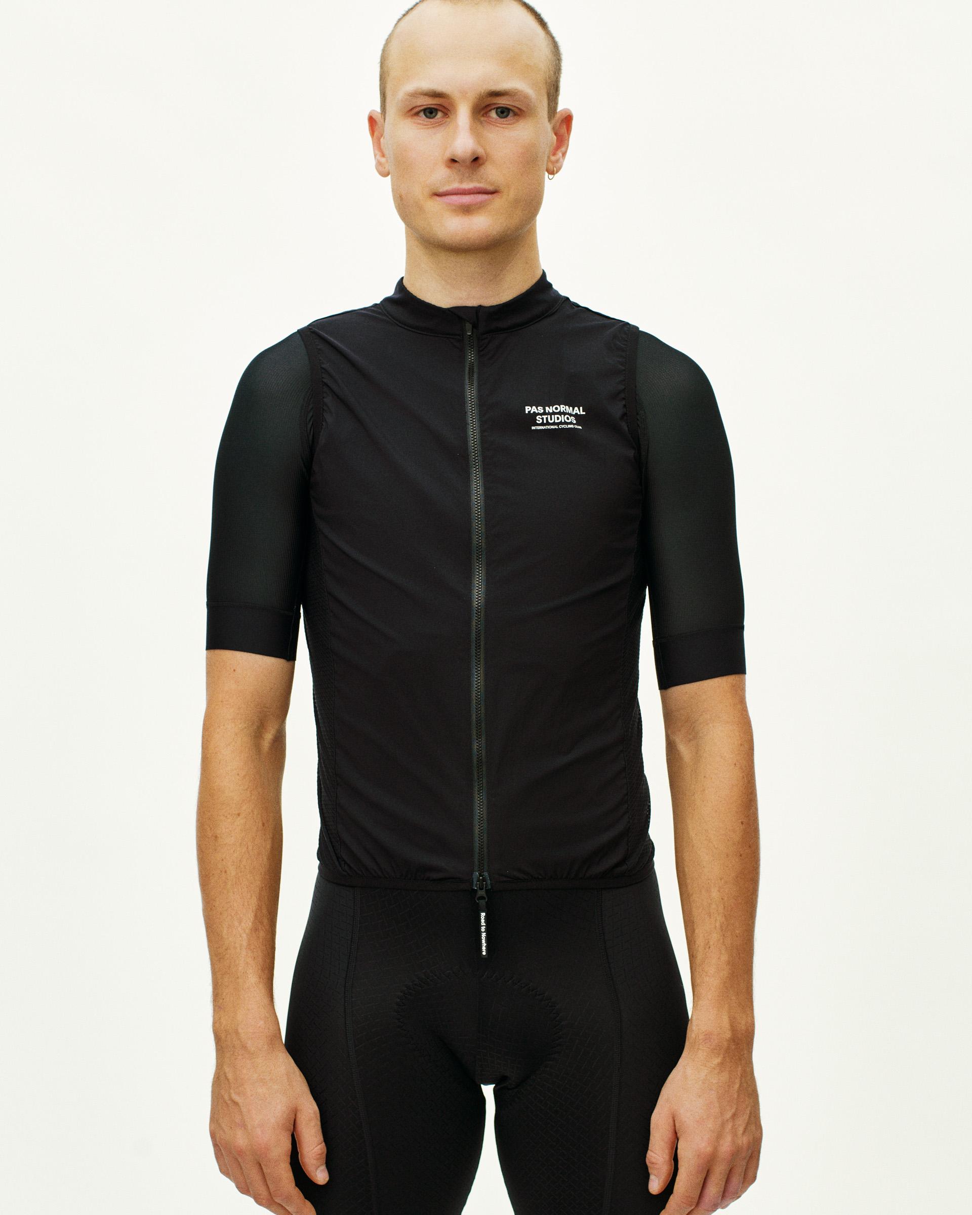 Black Mechanism Stow Away gilet on model, front view with full zip and chest logo