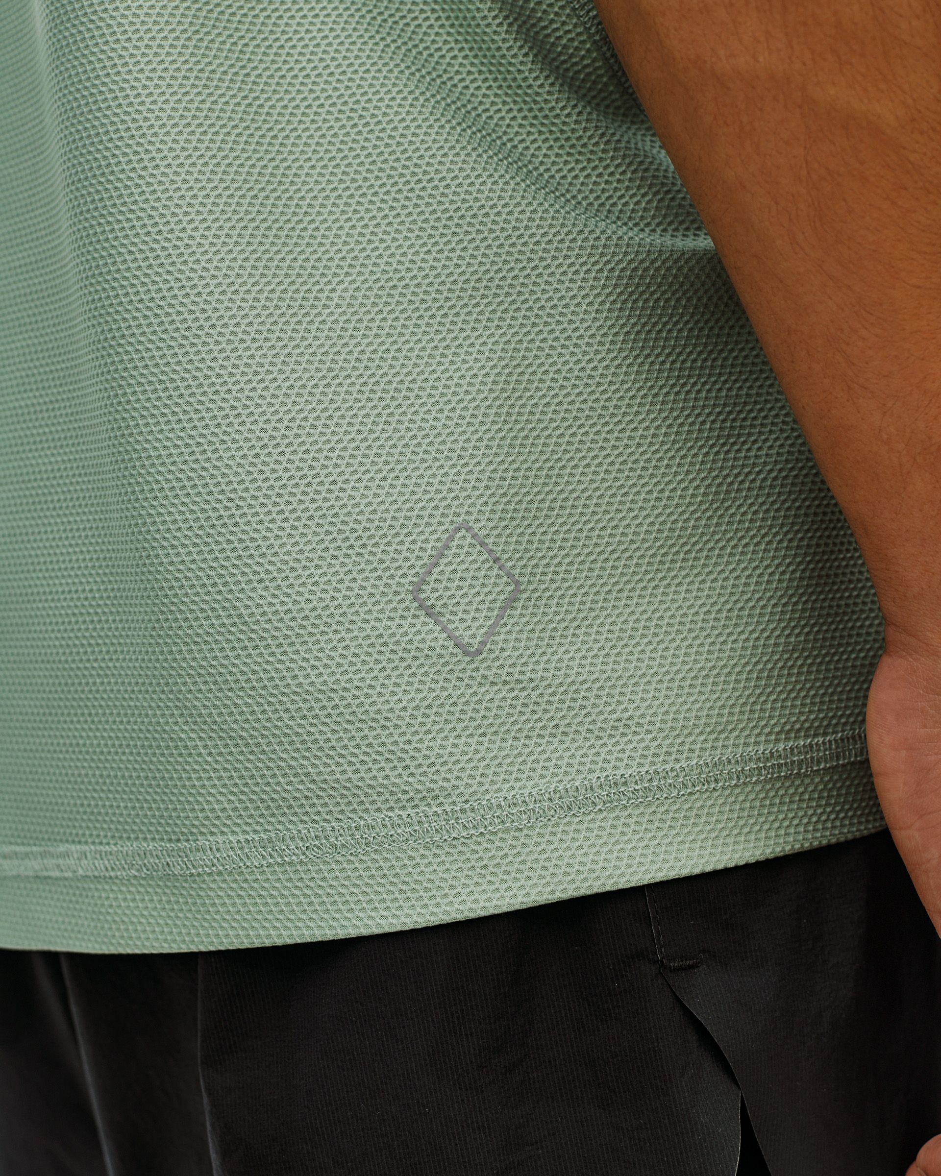 Green Sage Balance T-Shirt, detail view on model showing textured fabric and tonal diamond logo