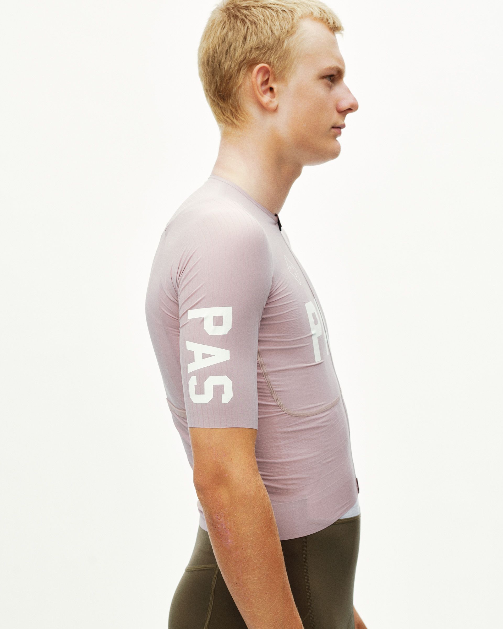 Taupe Rose PAS Mechanism Pro cycling jersey on model, side view with white sleeve and chest print