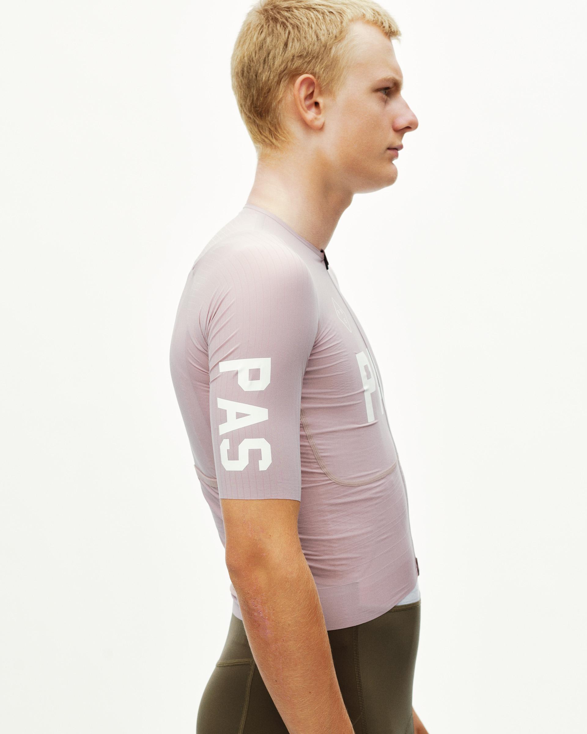 Taupe Rose PAS Mechanism Pro cycling jersey on model, side view with white sleeve and chest print