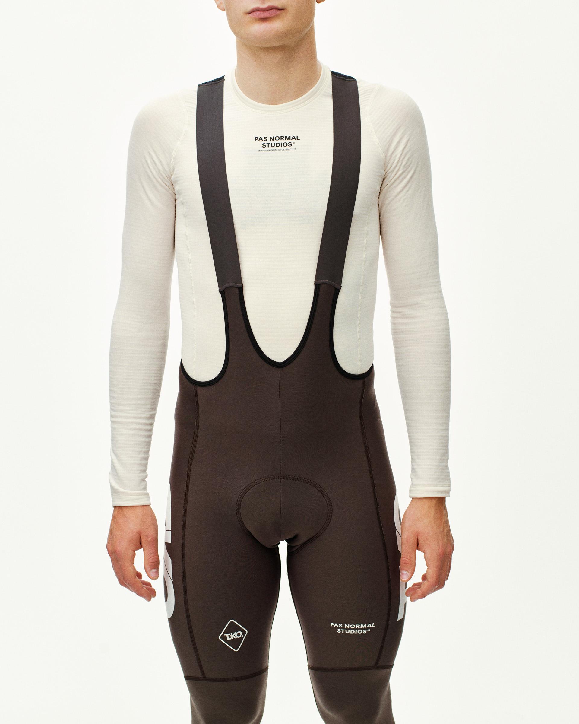 Dark Purple T.K.O. Essential Thermal Long cycling bibs on model, front view with white logo print