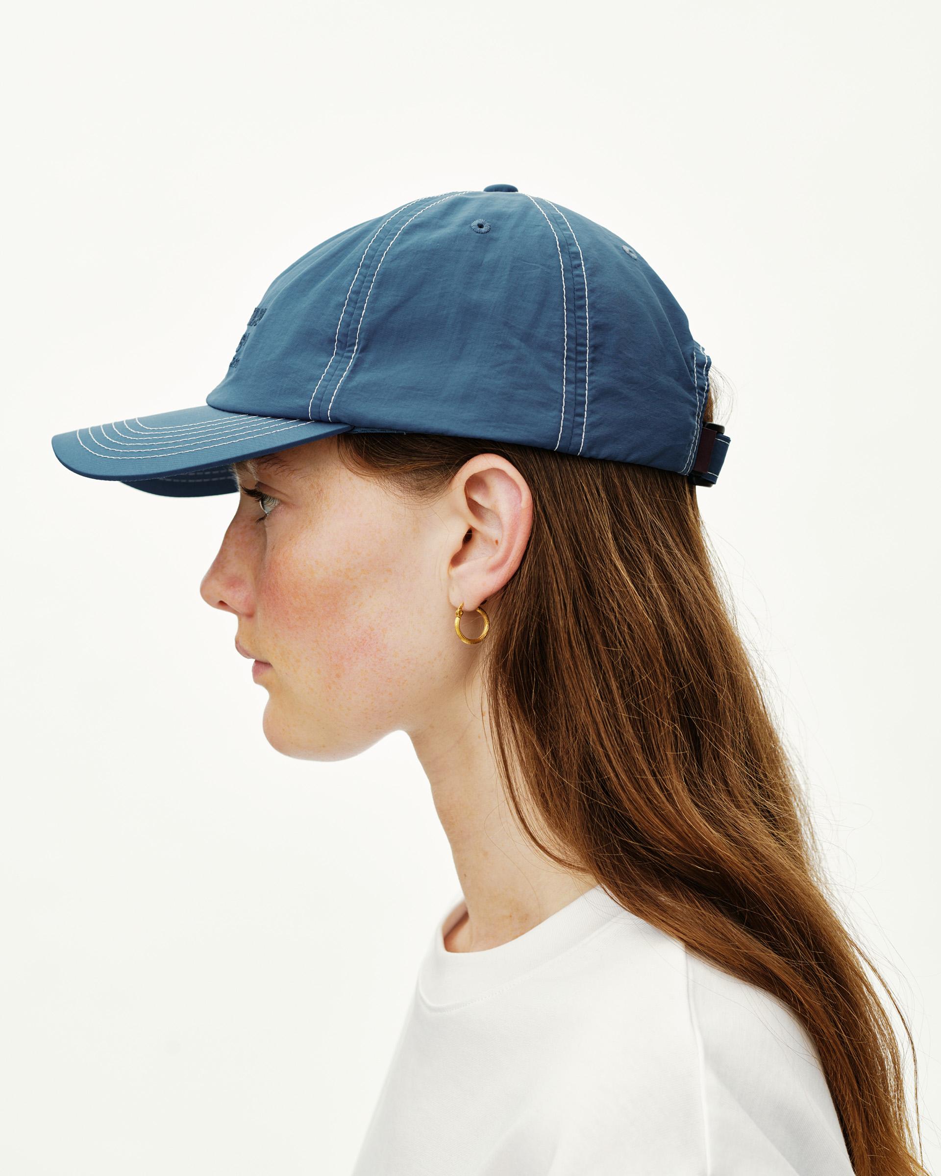 Ocean Blue Off-Race cap on model, side view with contrast white stitching