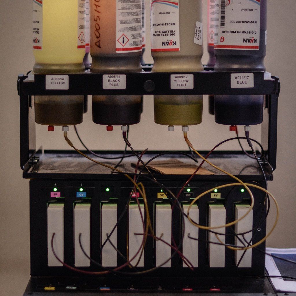 Industrial ink dispensing system with yellow, black, fluorescent yellow and blue cartridges for textile printing