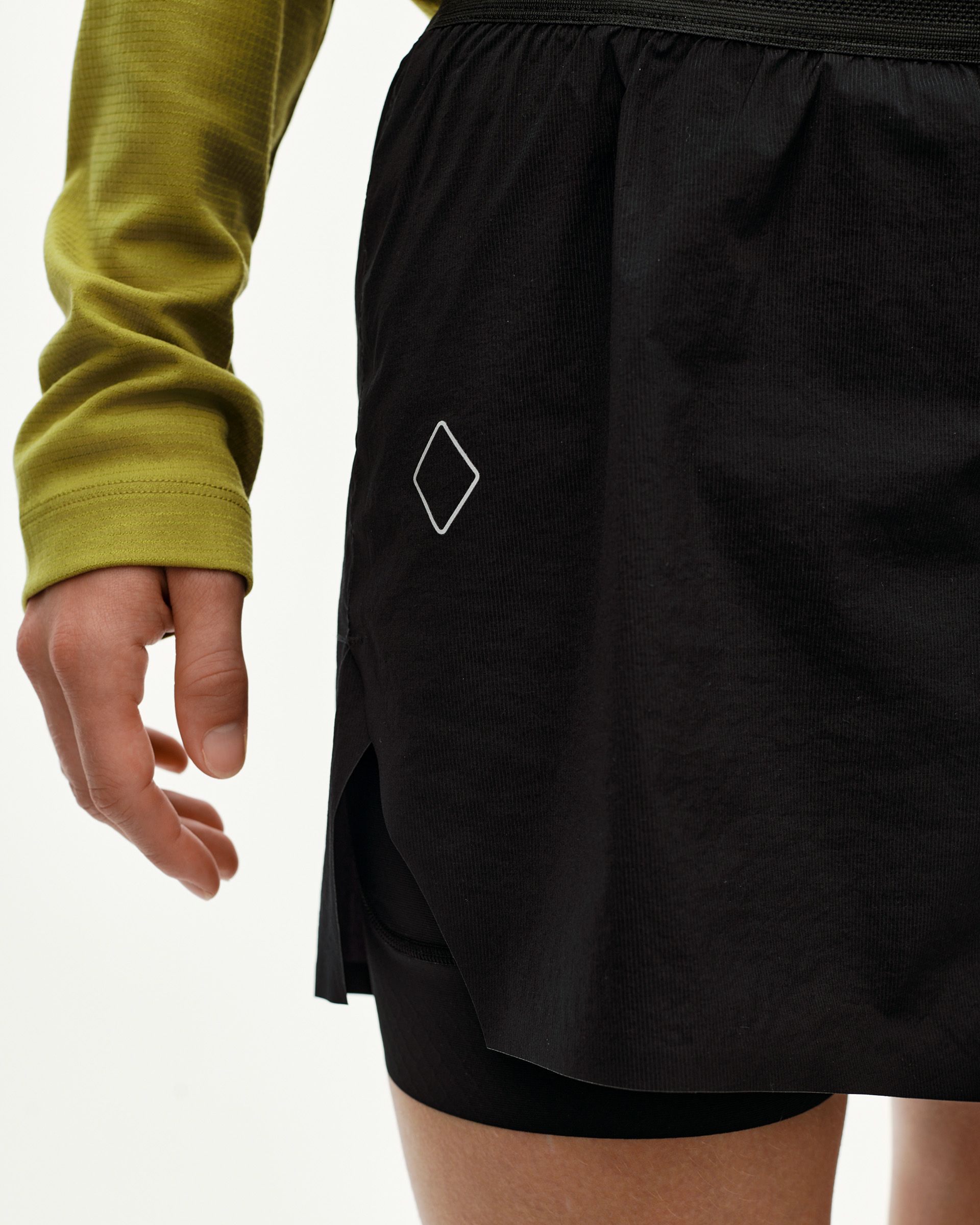 Black Balance 2-in-1 shorts, side detail on model with diamond logo print