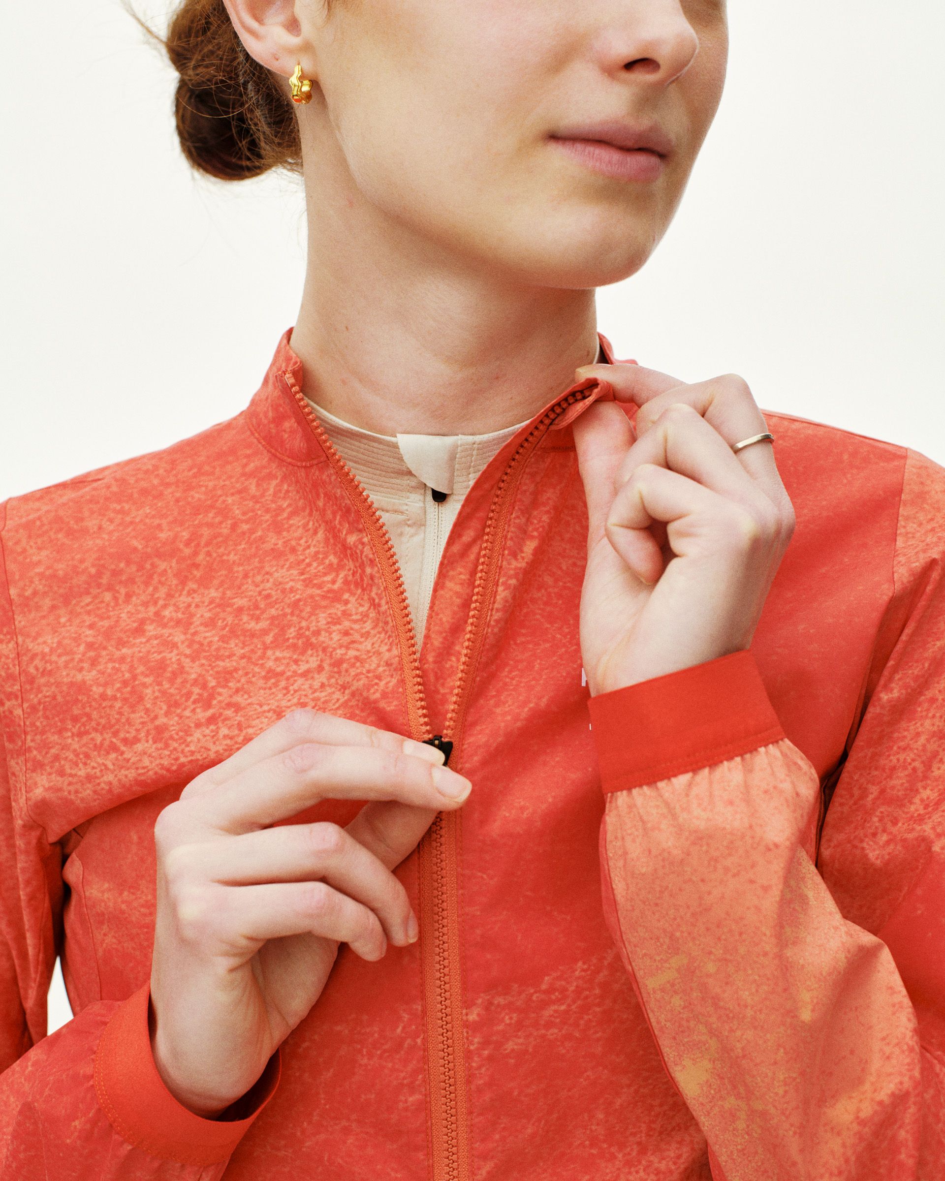 Orange Mechanism Stow Away jacket on model with front zip and contrast panels
