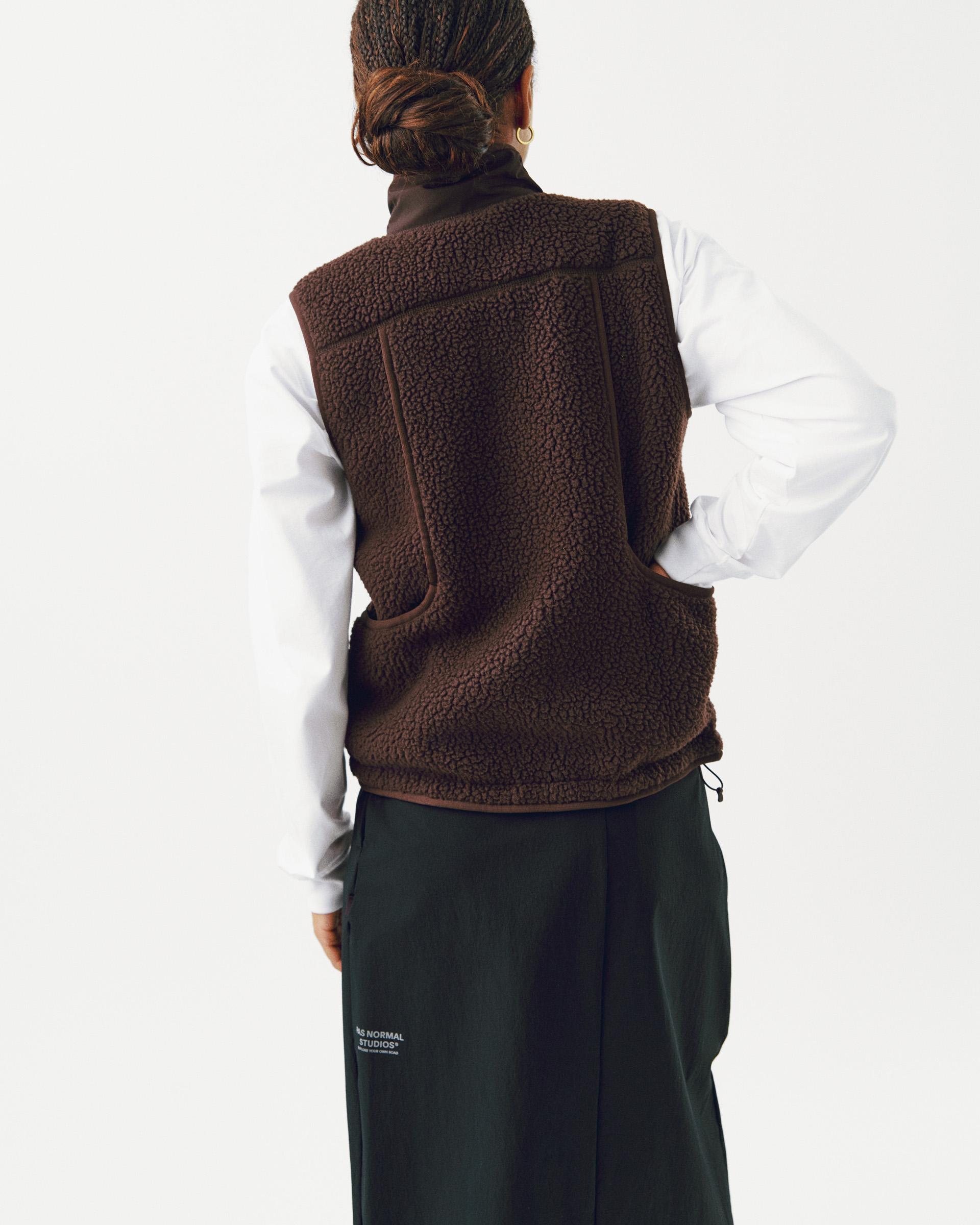 Brown Off-Race Pile Fleece vest, rear view on model with textured fleece and contrast piping
