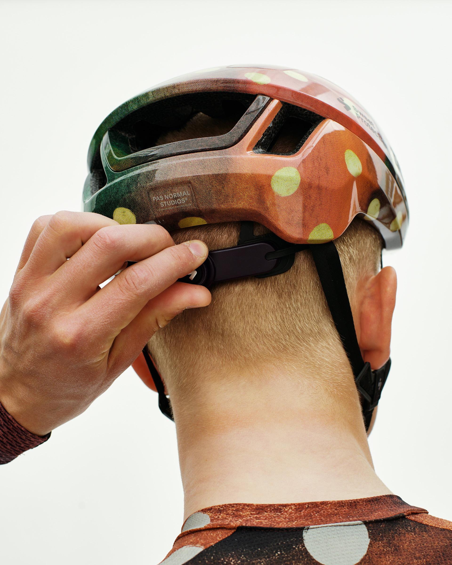 Brown T.K.O. Falconer Aero 2Vi cycling helmet on model, rear three-quarter view with polka dot pattern