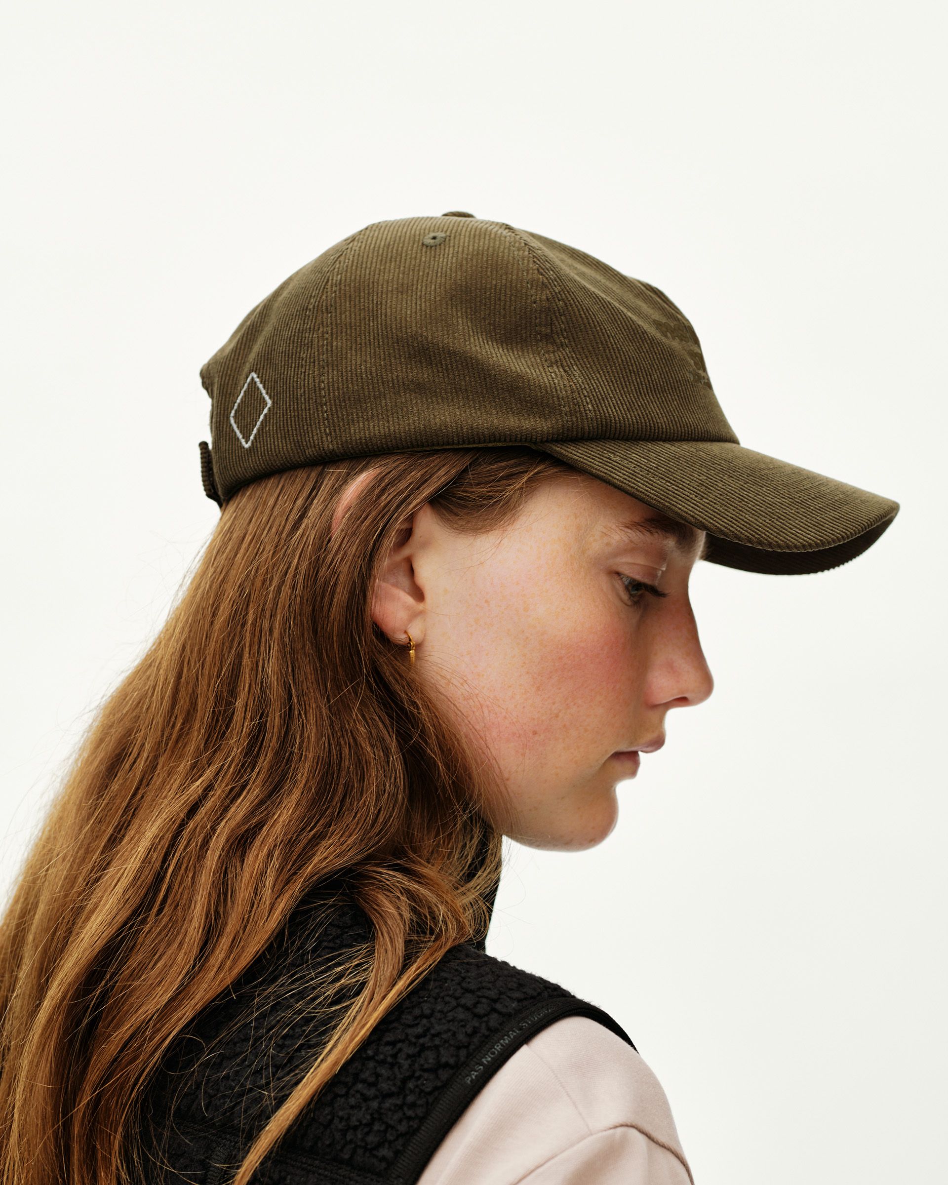 Deep Olive Off-Race Tech Corduroy cap on model, side view with white diamond logo embroidery