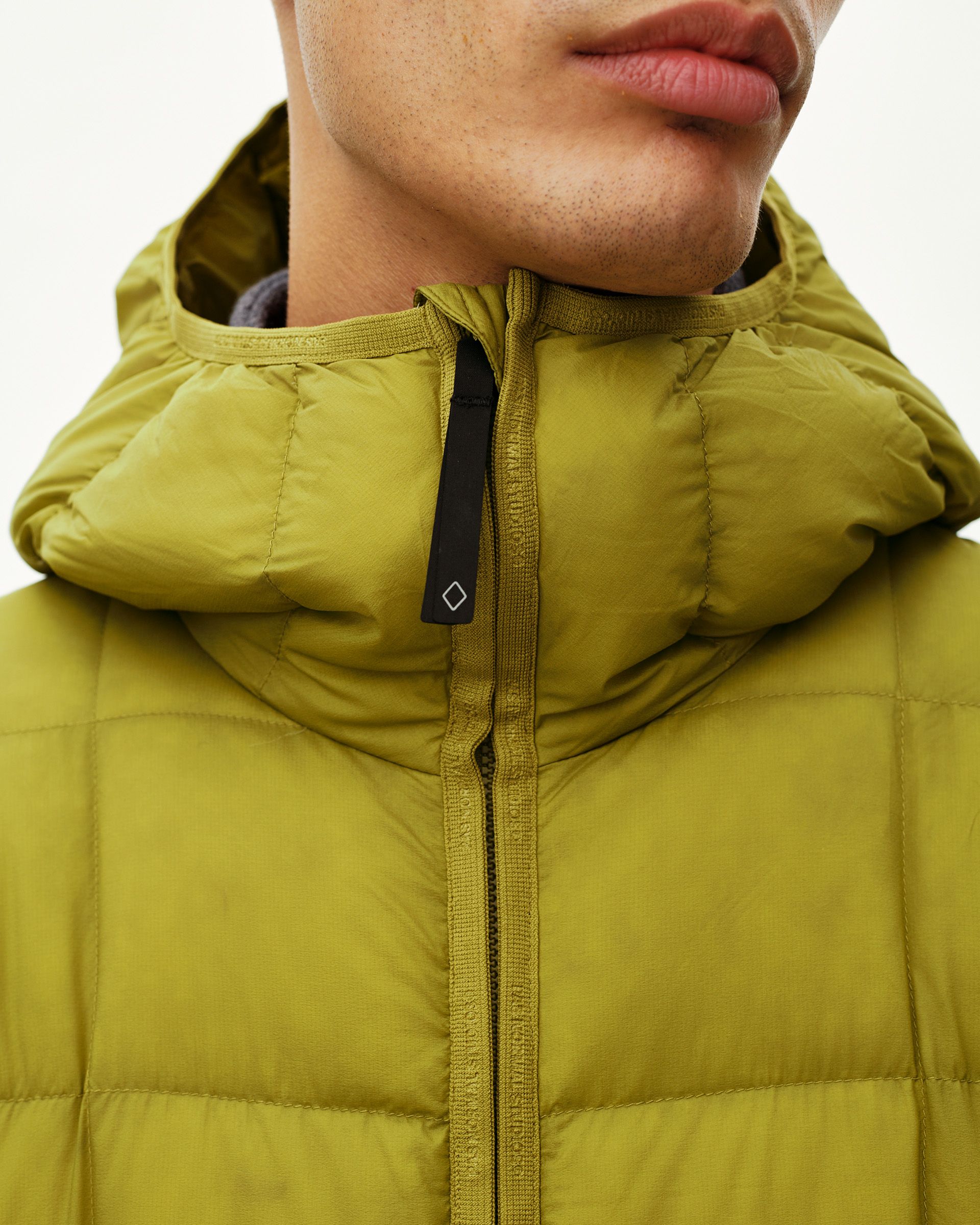 Dark Lime green Off-Race Down Liner jacket, front detail on model showing hood and branded zip tape