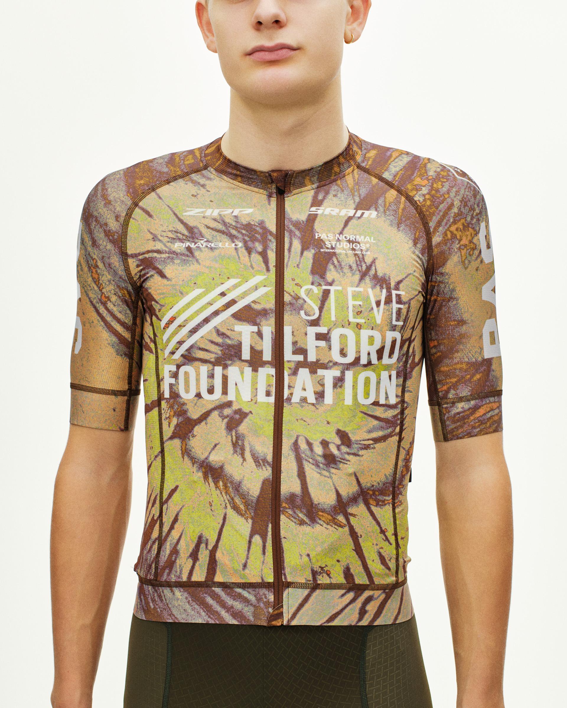 Beige STFR Mechanism cycling jersey on model with botanical print and white foundation text