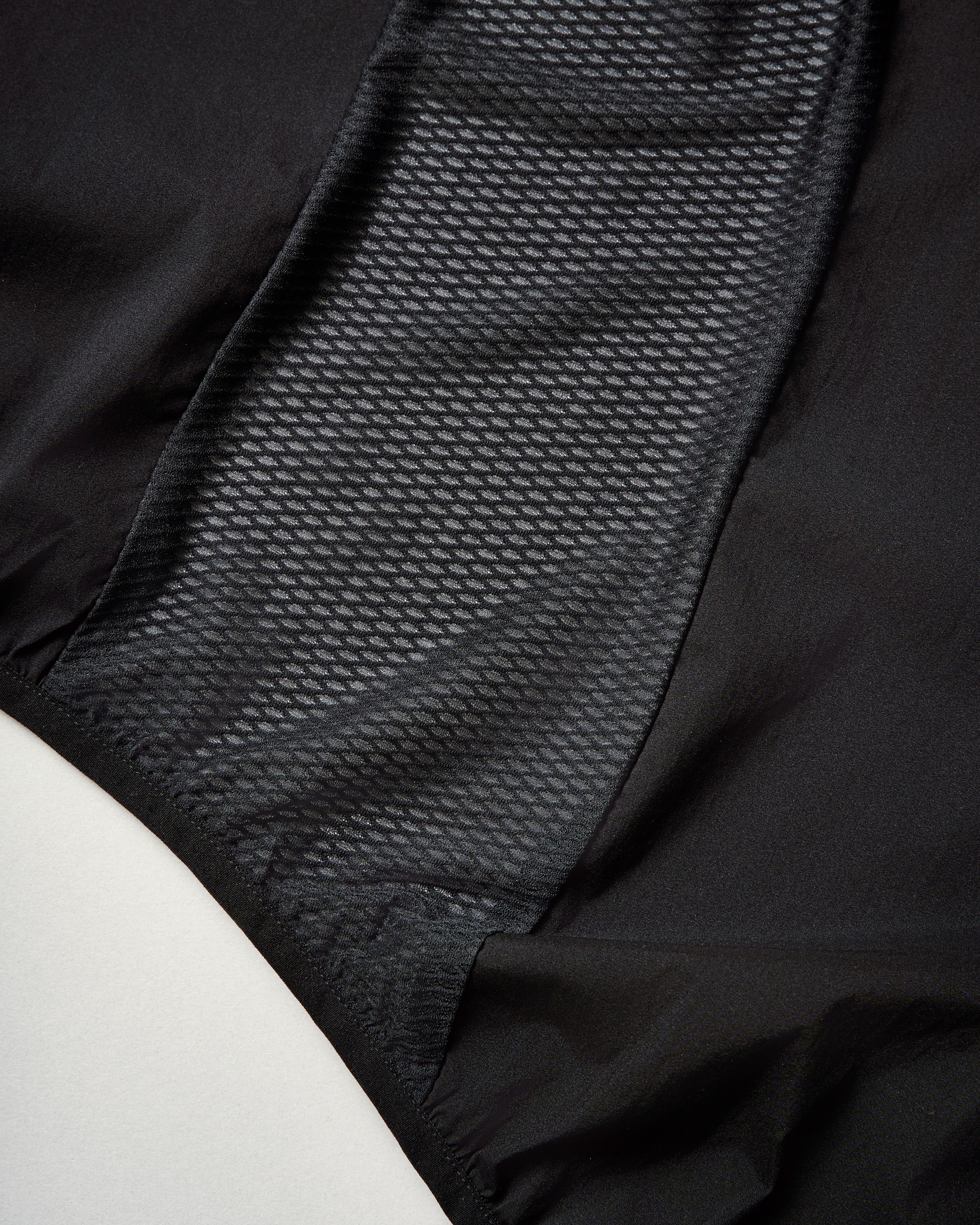Grey Mechanism Stow Away gilet detail view with textured mesh panel