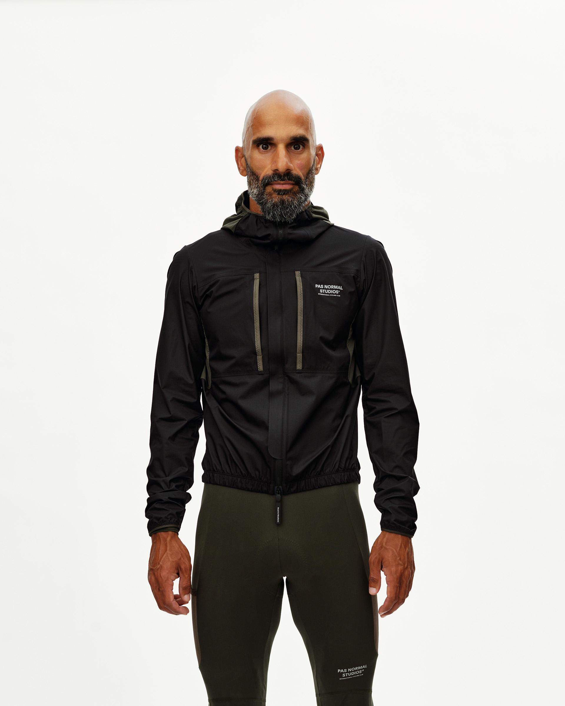 Black Escapism Hooded Lightweight cycling jacket on model, front view with olive zip trim and chest pocket