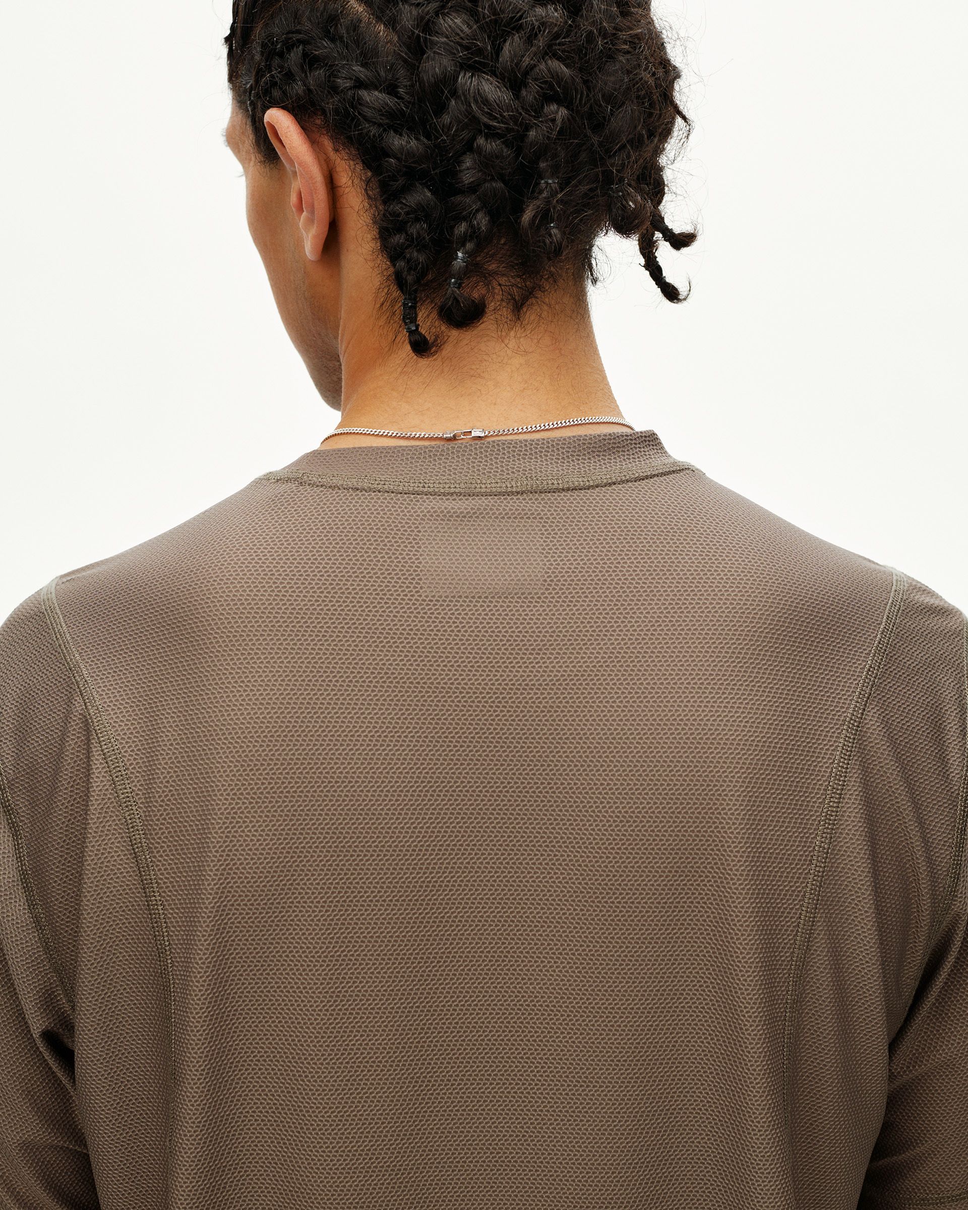 Stone Brown Balance T-shirt on model, rear view with textured fabric and contrast neck tape