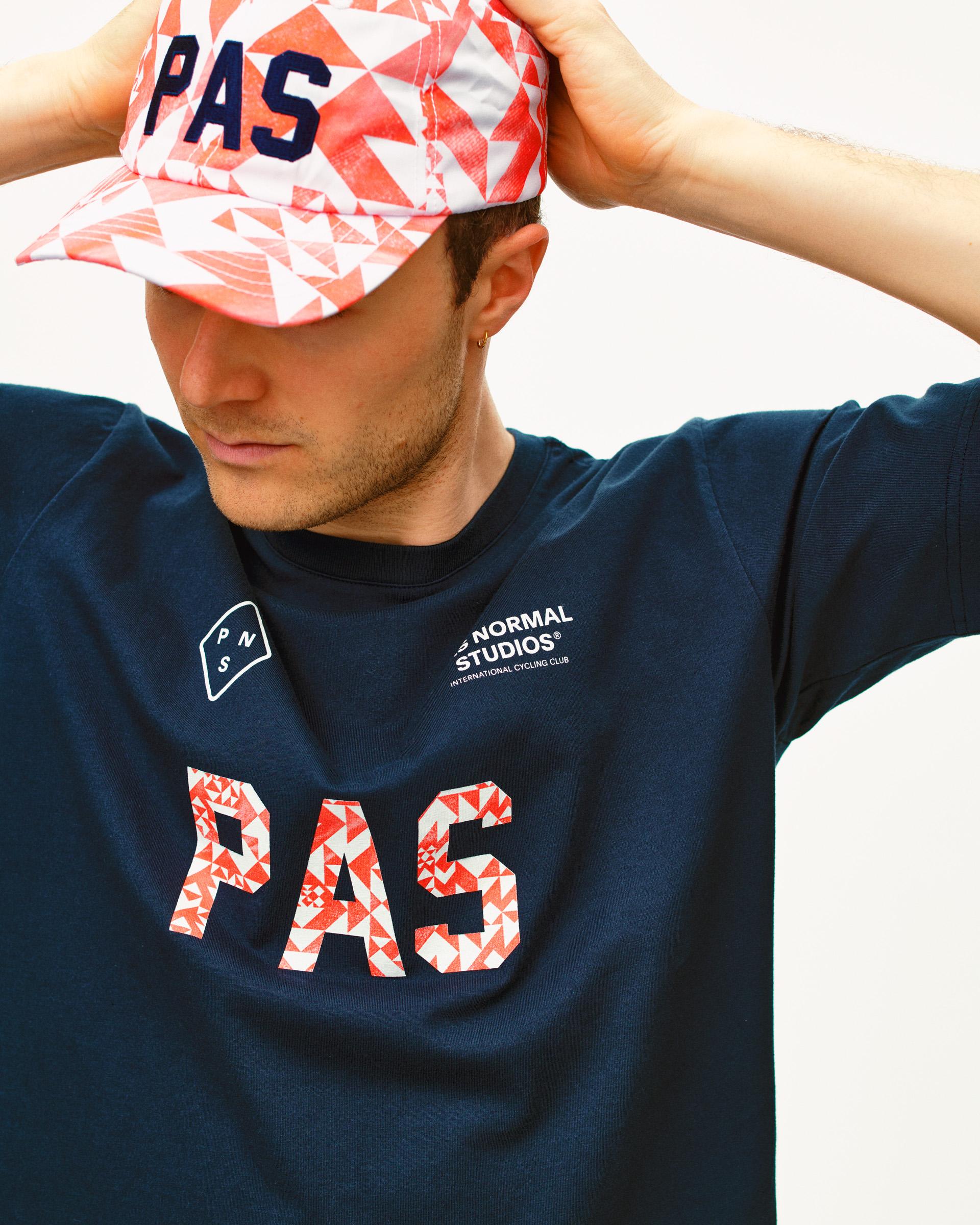 Orange PAS Off-Race cap on model with geometric origami print
