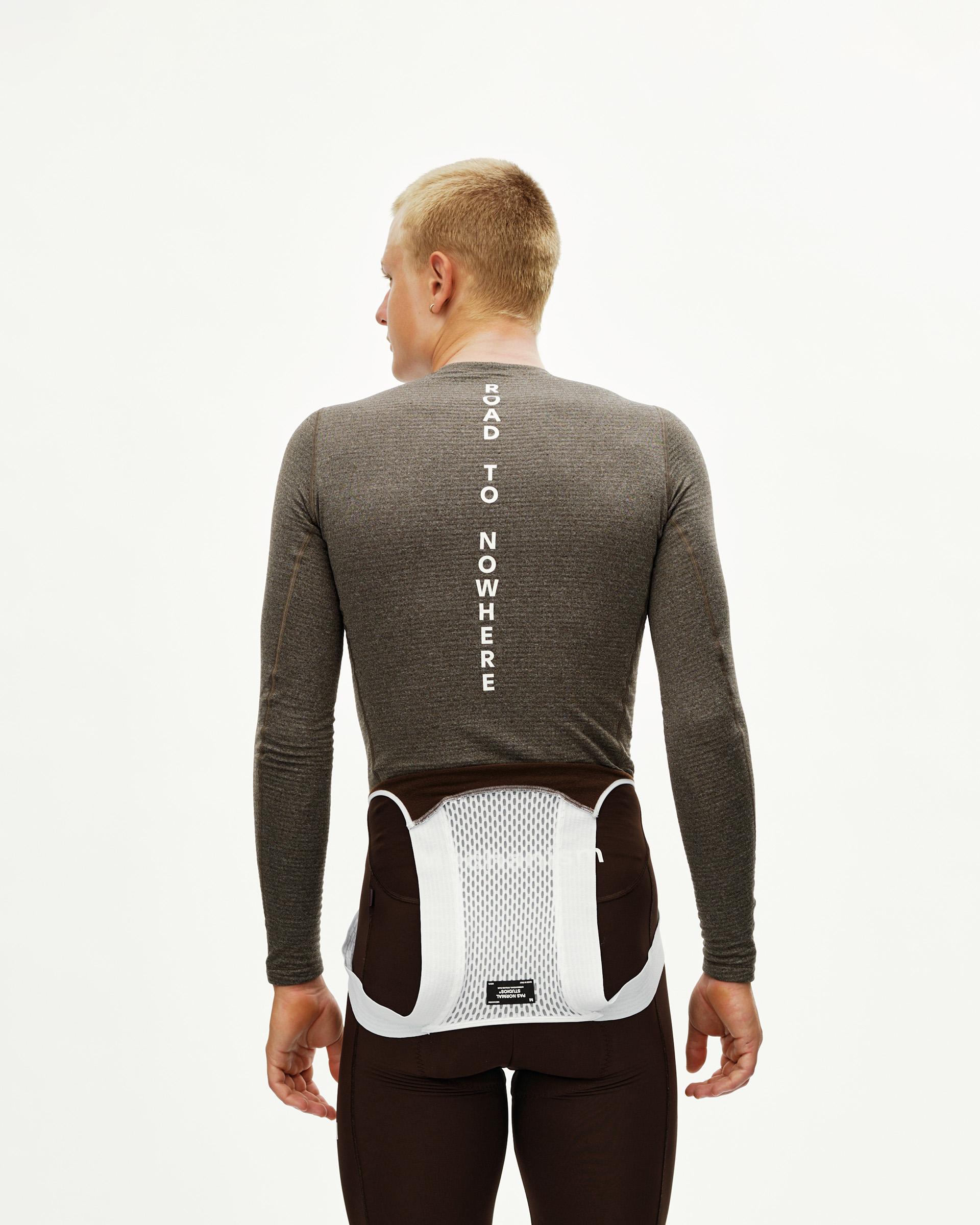 Dark Coffee brown Essential thermal long sleeve cycling baselayer on model, rear view with Road To Nowhere back print