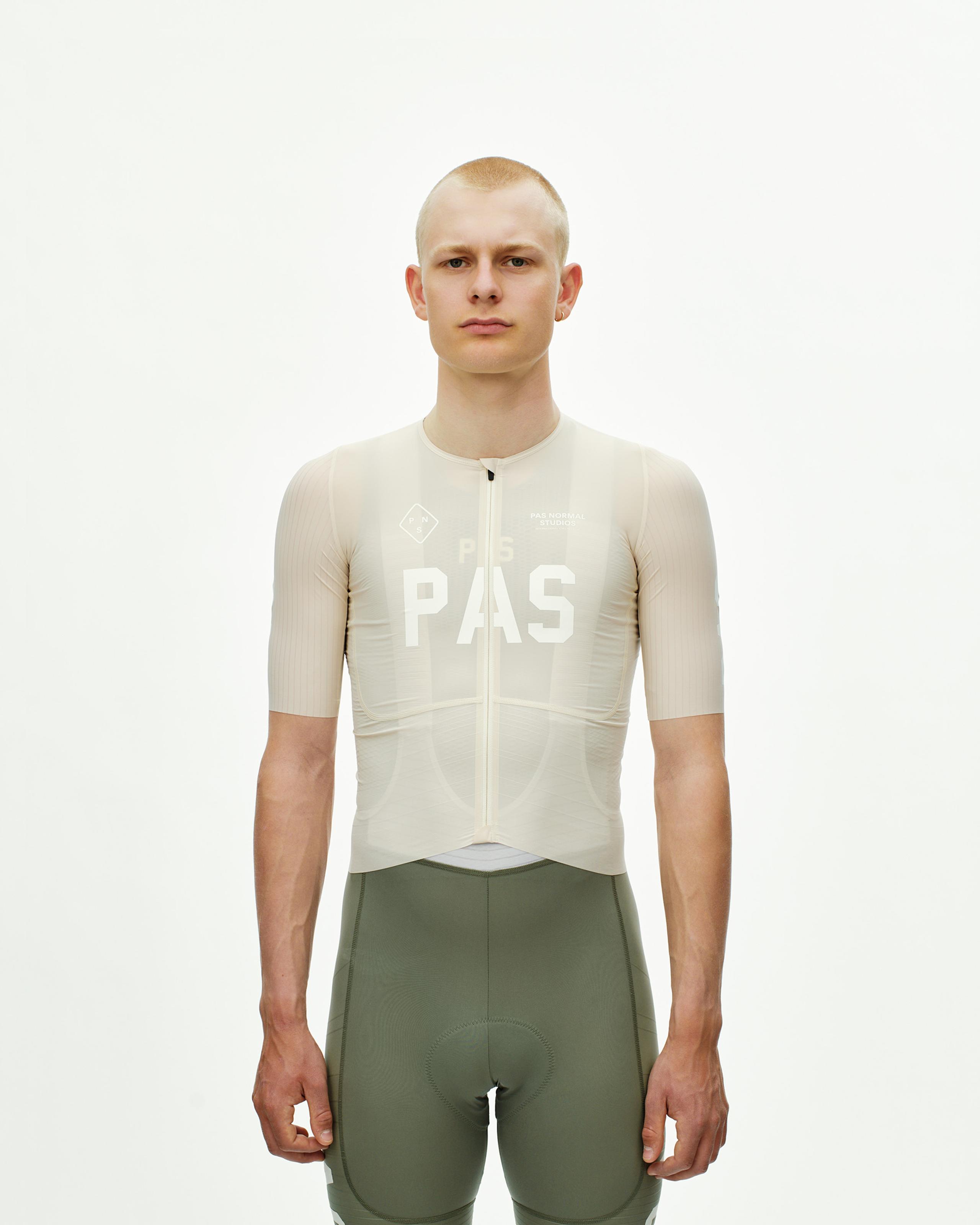 Cream PAS Mechanism Pro cycling jersey on model with white chest print