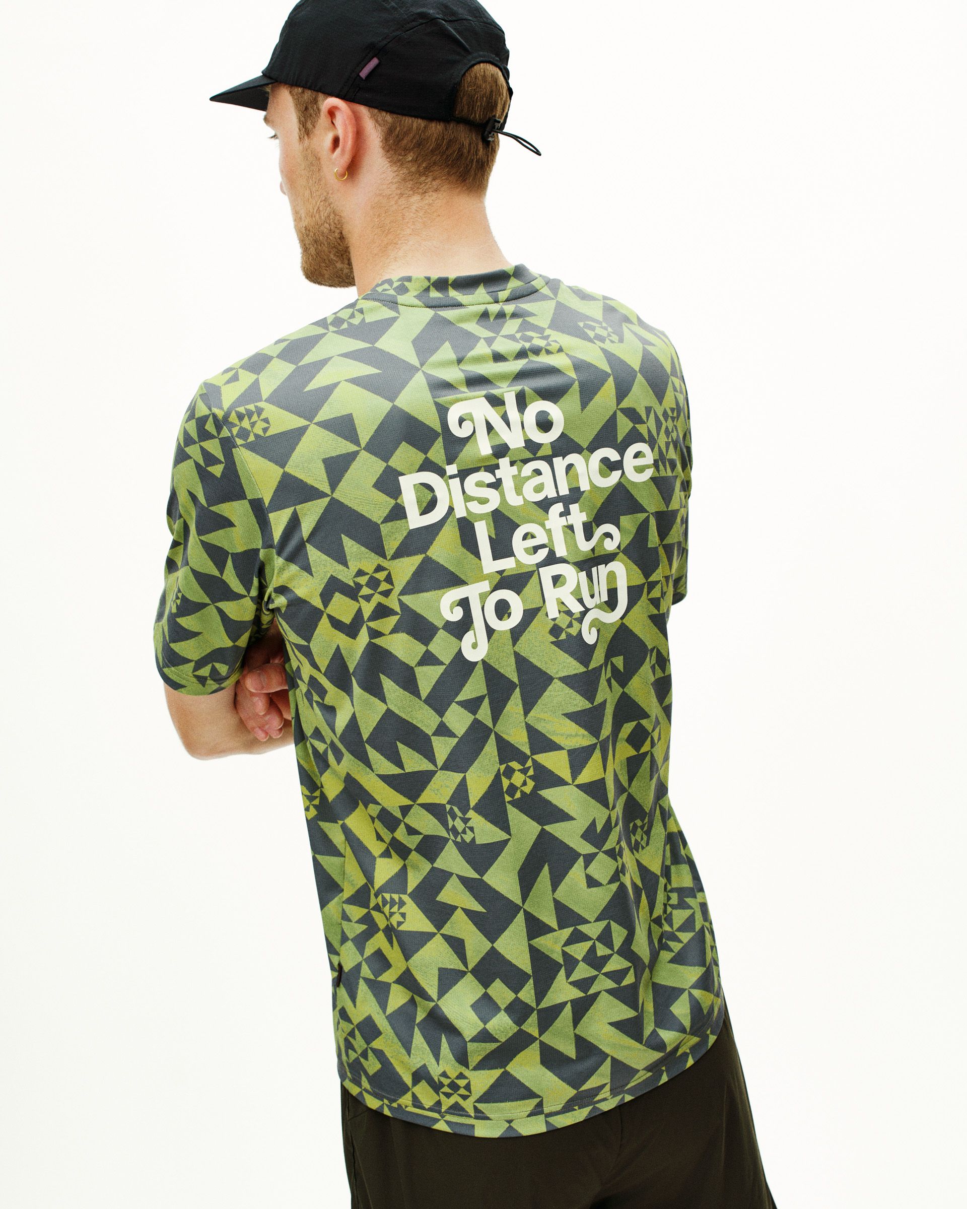Green Balance t-shirt on model, rear view with geometric print and white text
