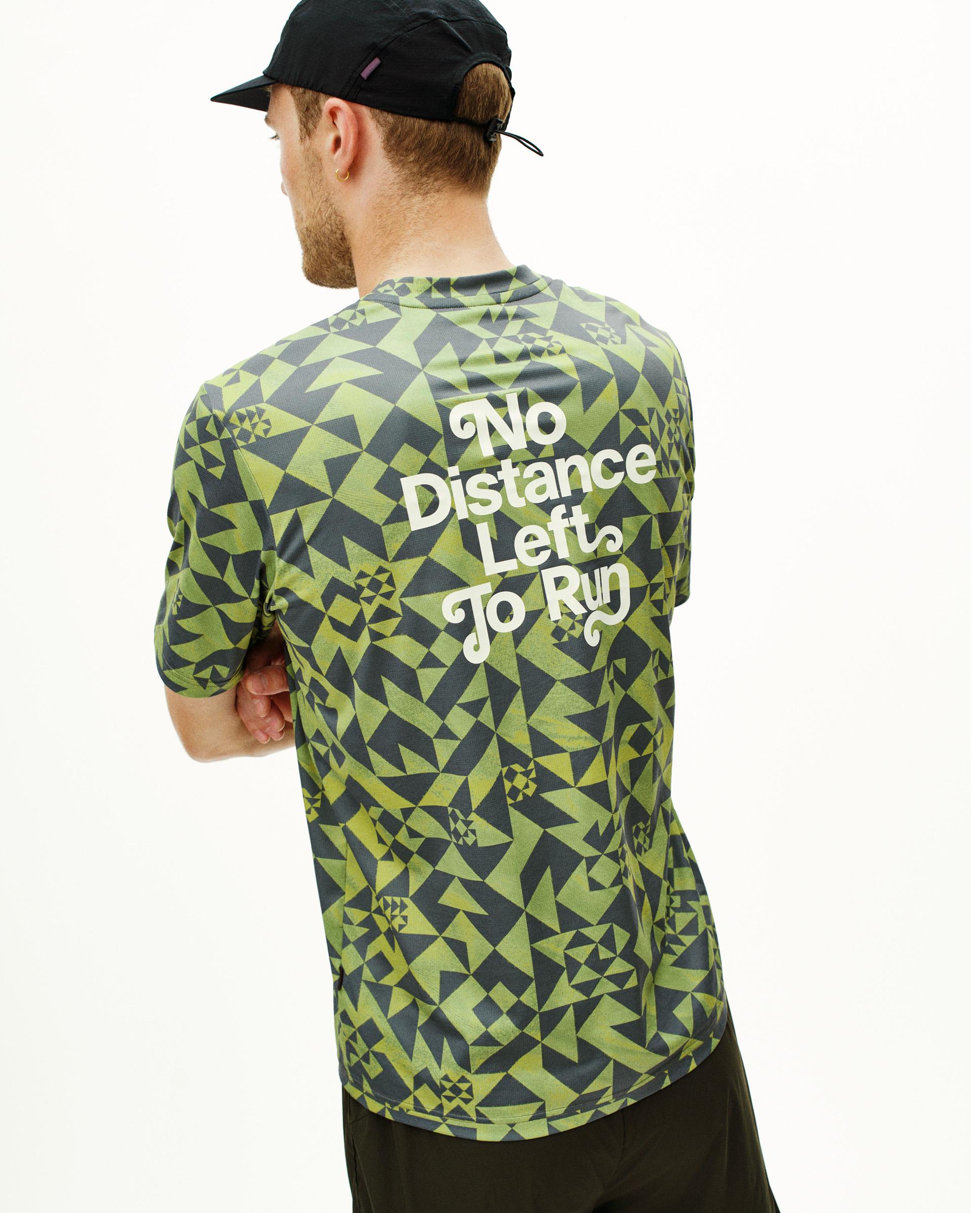Green Balance t-shirt on model, rear view with geometric print and white text