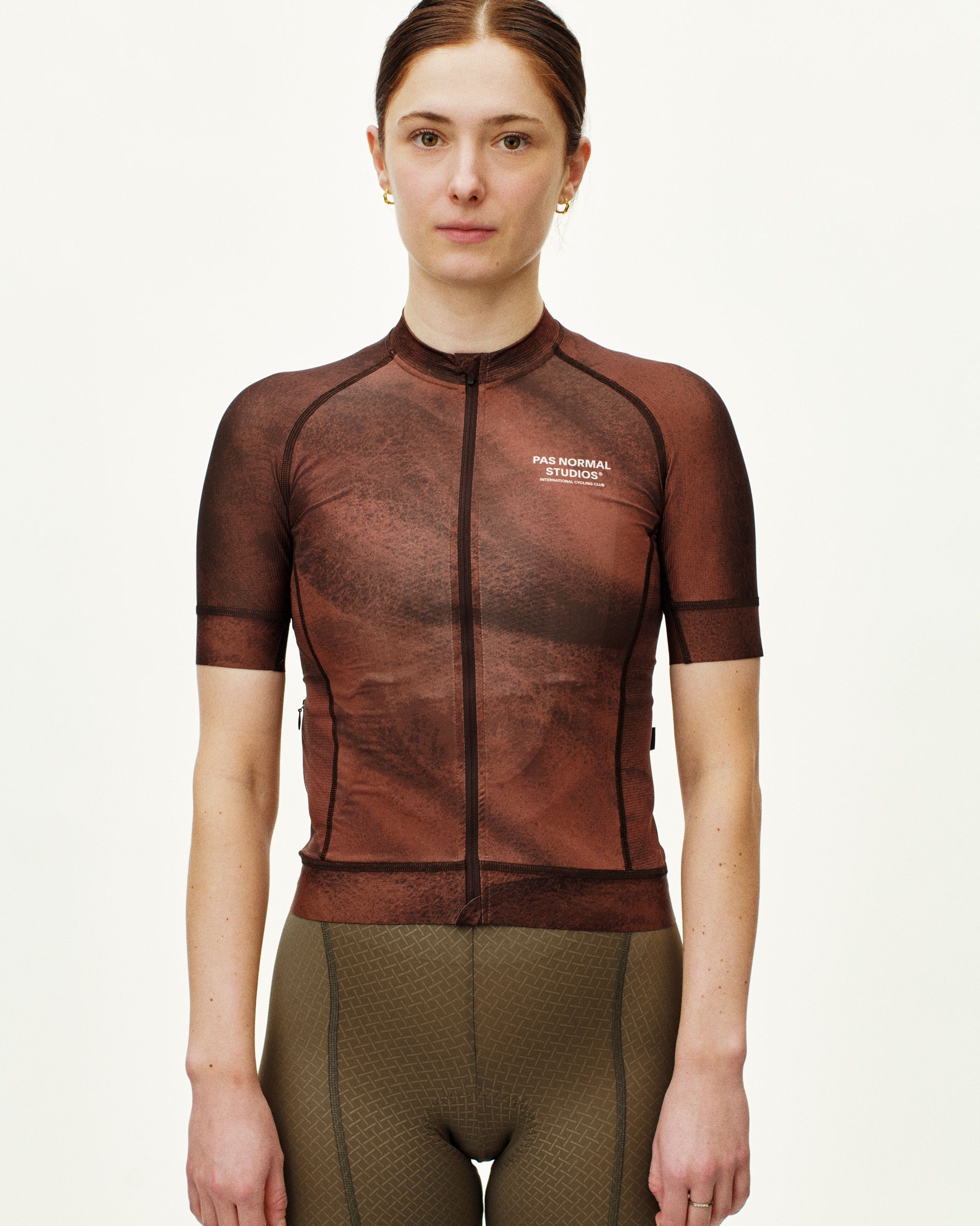 Brown Mechanism cycling jersey on model, front view with textured print and white chest logo