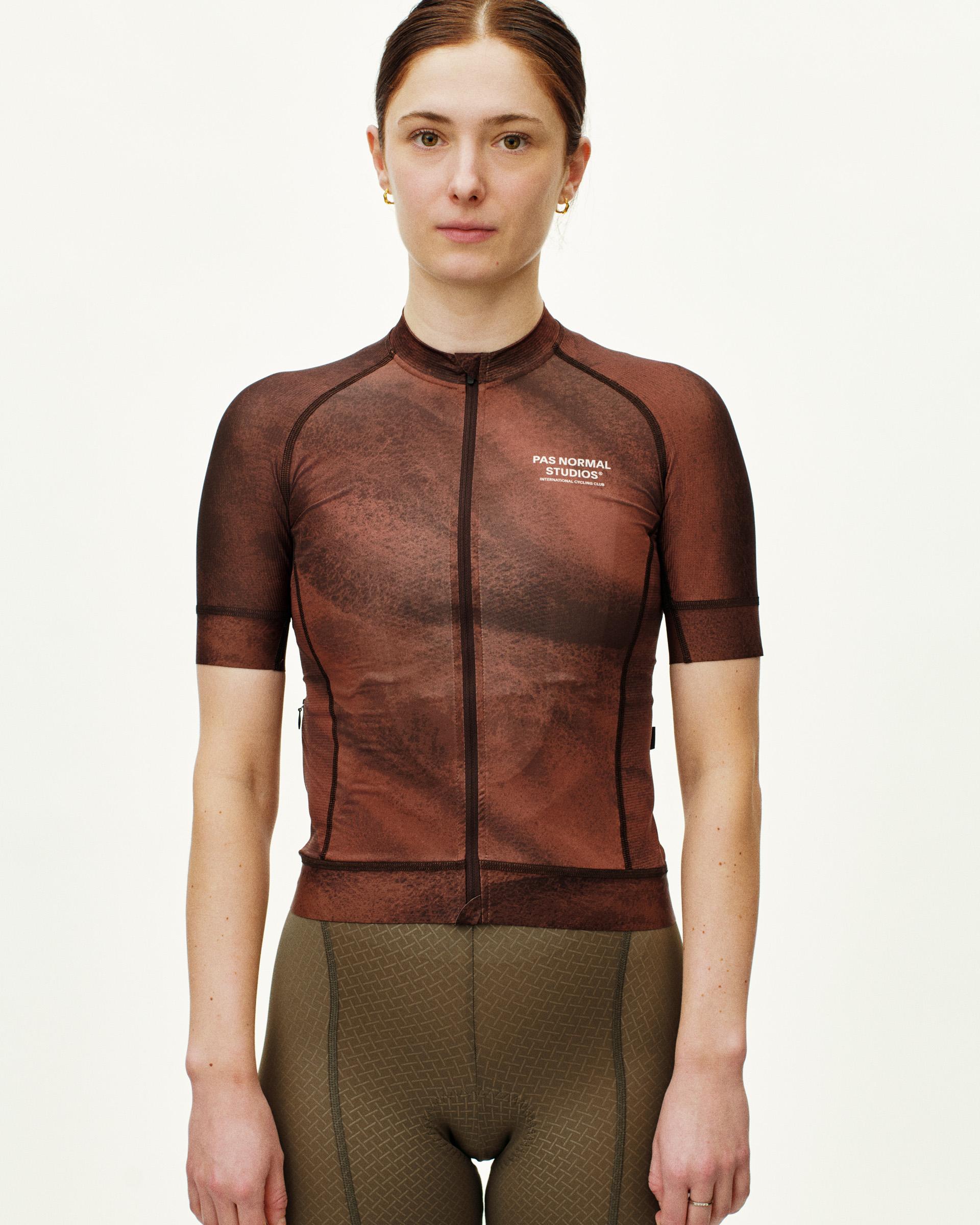 Brown Mechanism cycling jersey on model, front view with textured print and white chest logo