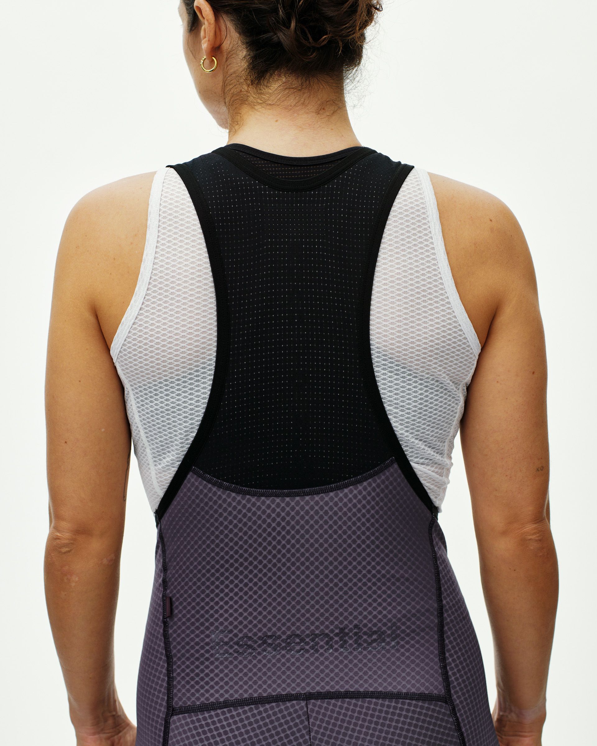 Grey Essential cycling bibs on model, rear view with black perforated back panel