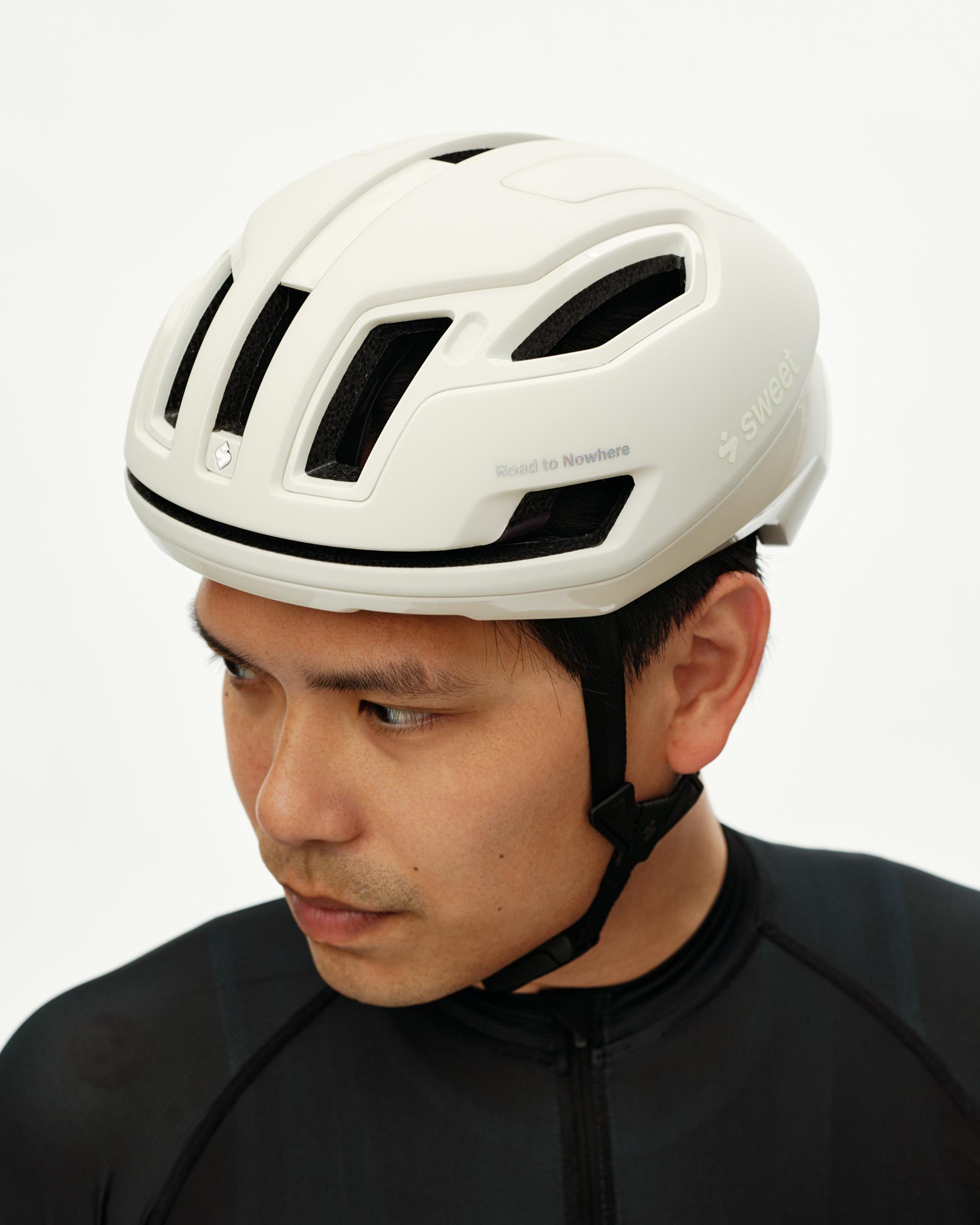 Off White Sweet Protection Falconer Aero 2Vi MIPS Round Fit cycling helmet on model, three-quarter front view