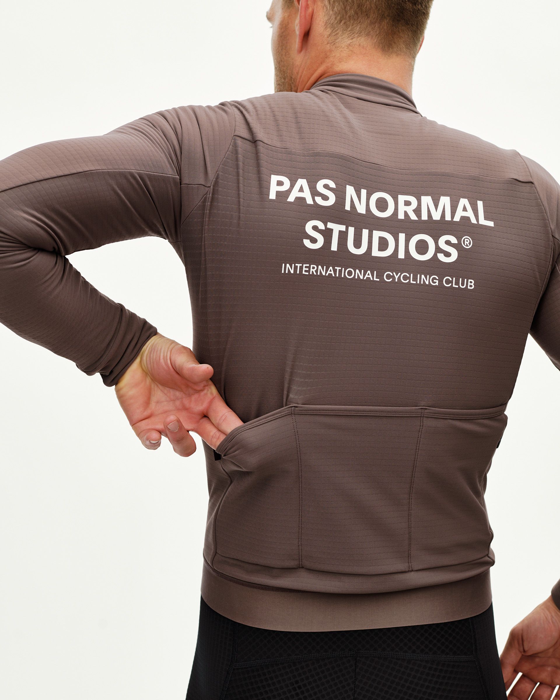Dusty Plum Essential long sleeve cycling jersey on model, rear view with white back print and three rear pockets