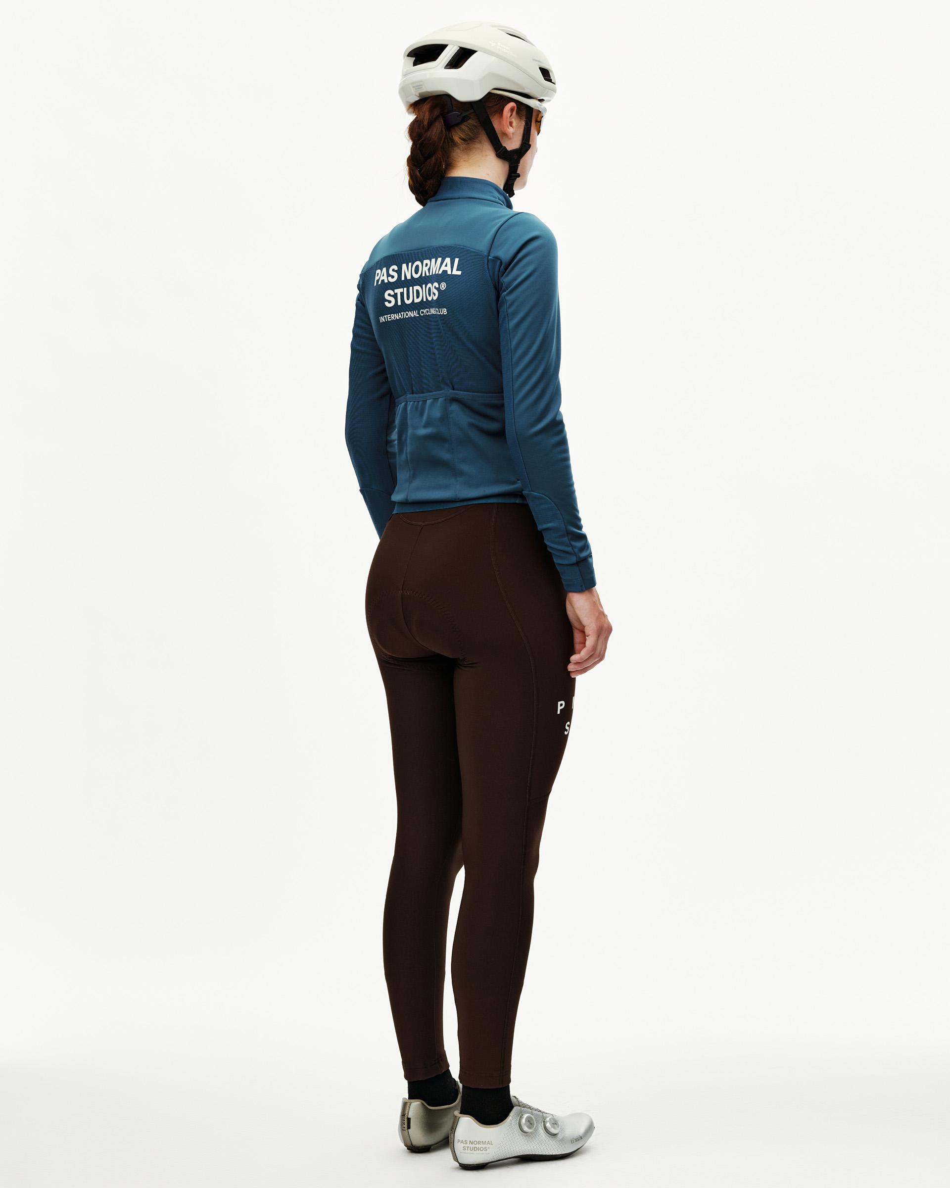 Denim Blue Mechanism Thermal long sleeve cycling jersey on model, rear view with white back print and rear pockets