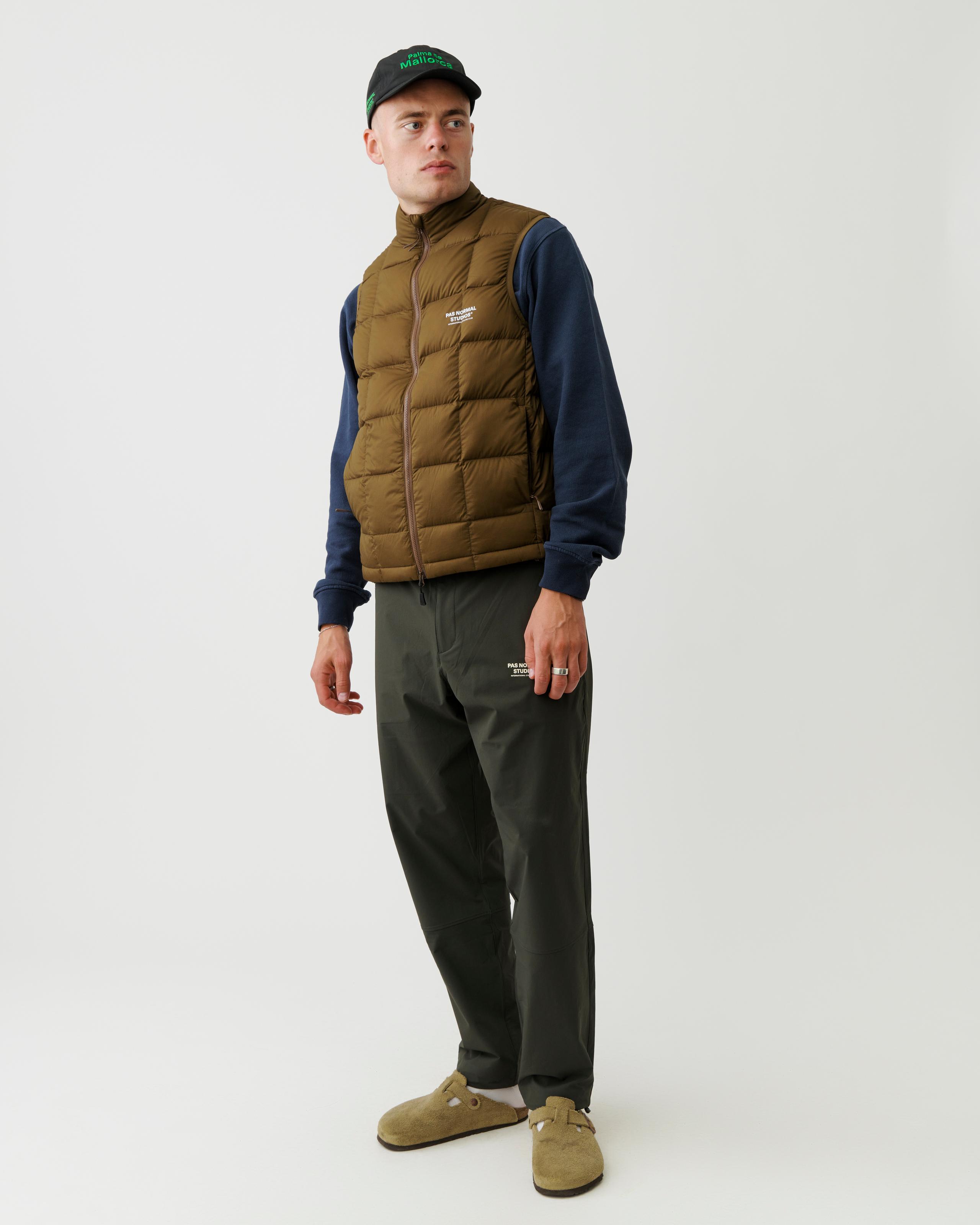 Brown Off-Race Down vest on model, quilted construction with white chest logo