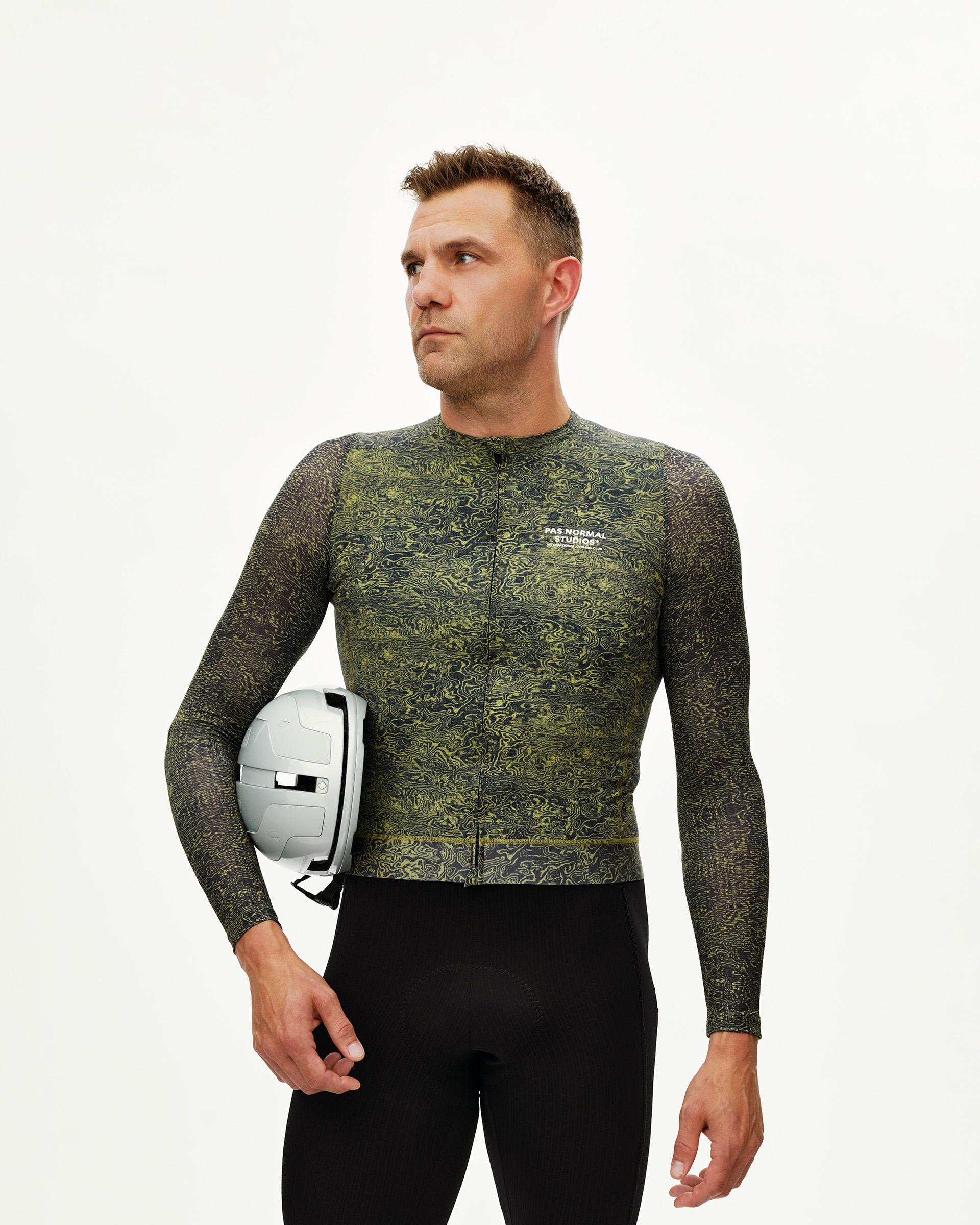 Dark Lime Essential long sleeve cycling jersey on model, front view with all-over swirl print