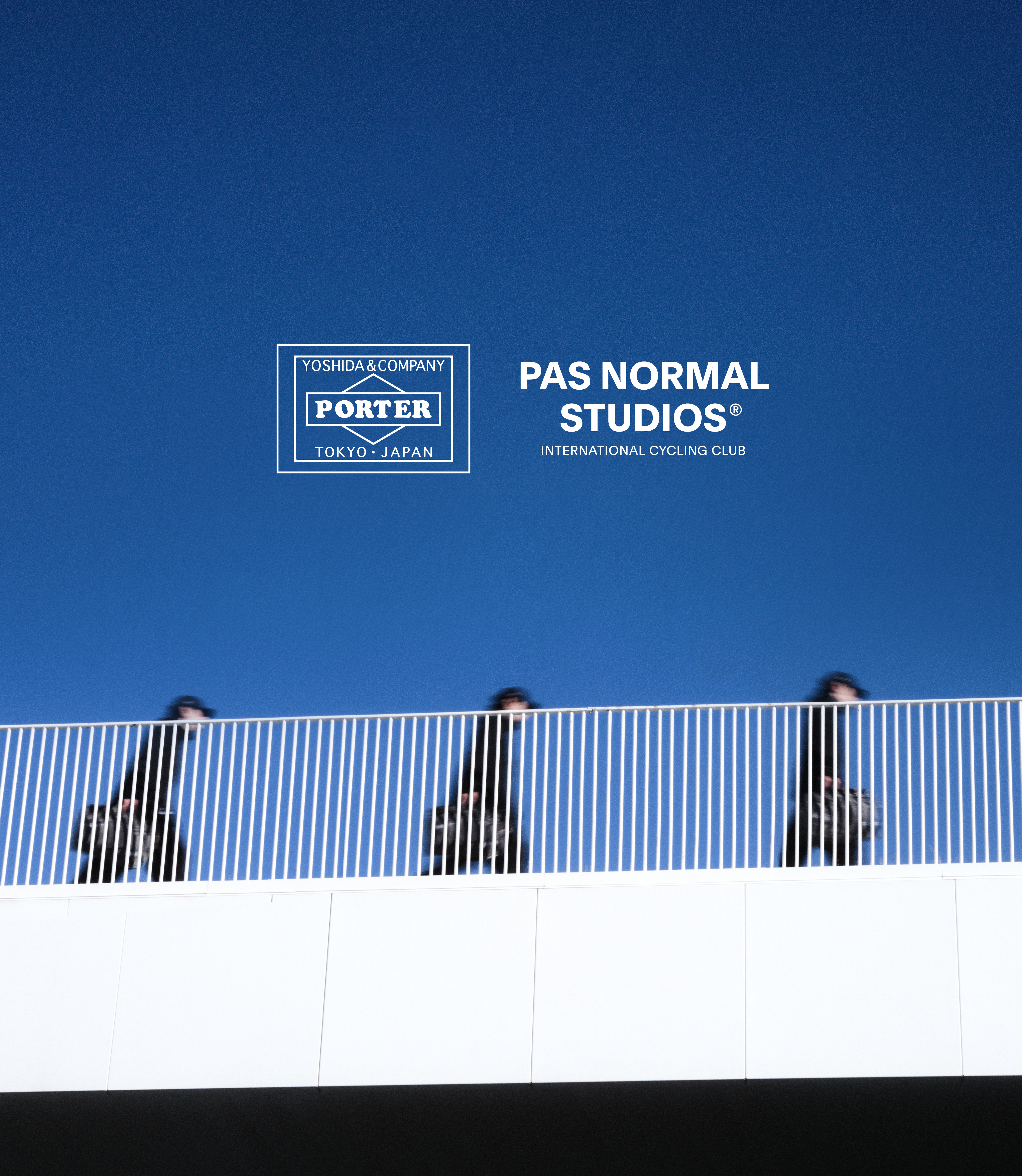 Blue sky with Porter and brand logos above three cyclists behind striped barrier