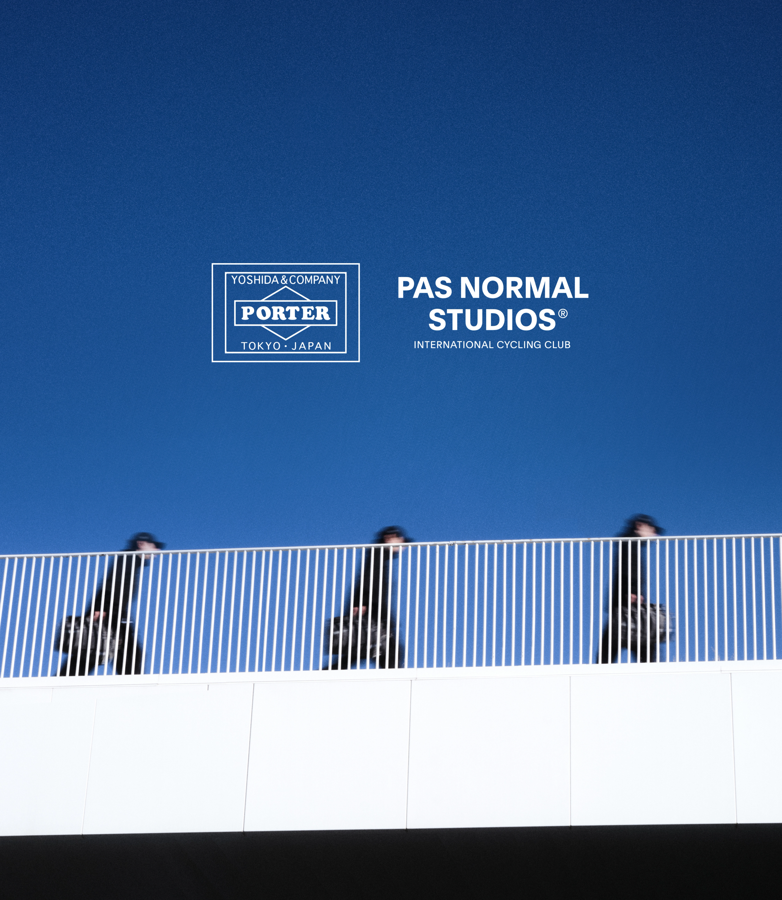 Blue sky with Porter and brand logos above three cyclists behind striped barrier