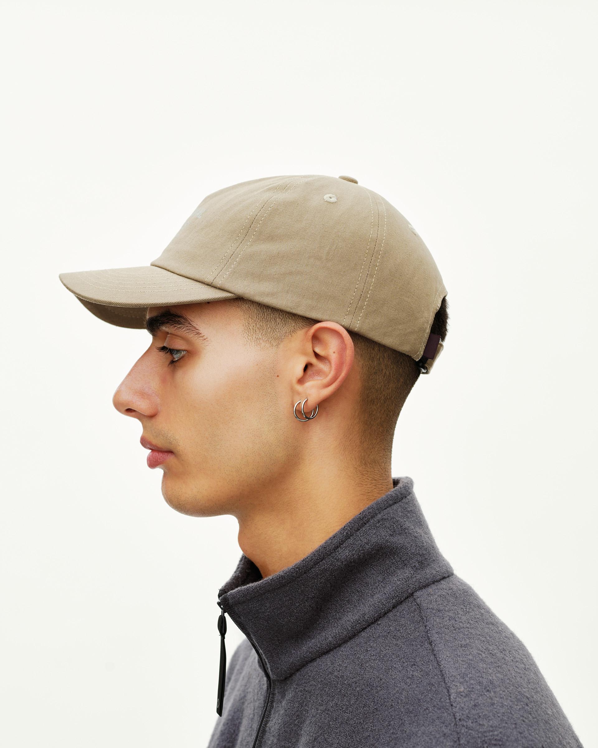 Dusty Earth khaki Off-Race Cotton Cap on model, side view with structured brim