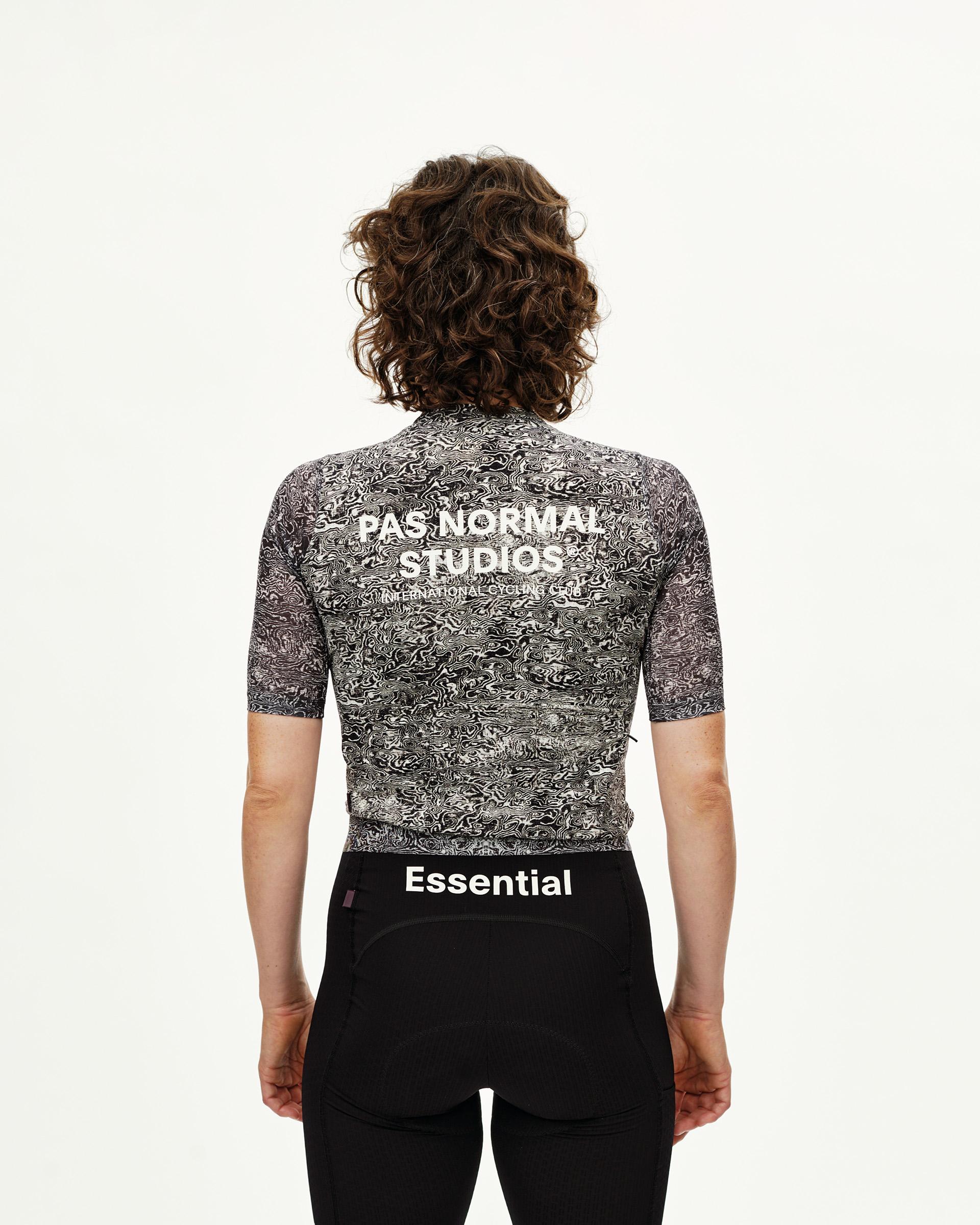Off White Essential cycling jersey on model, rear view with abstract swirl print and white back logo