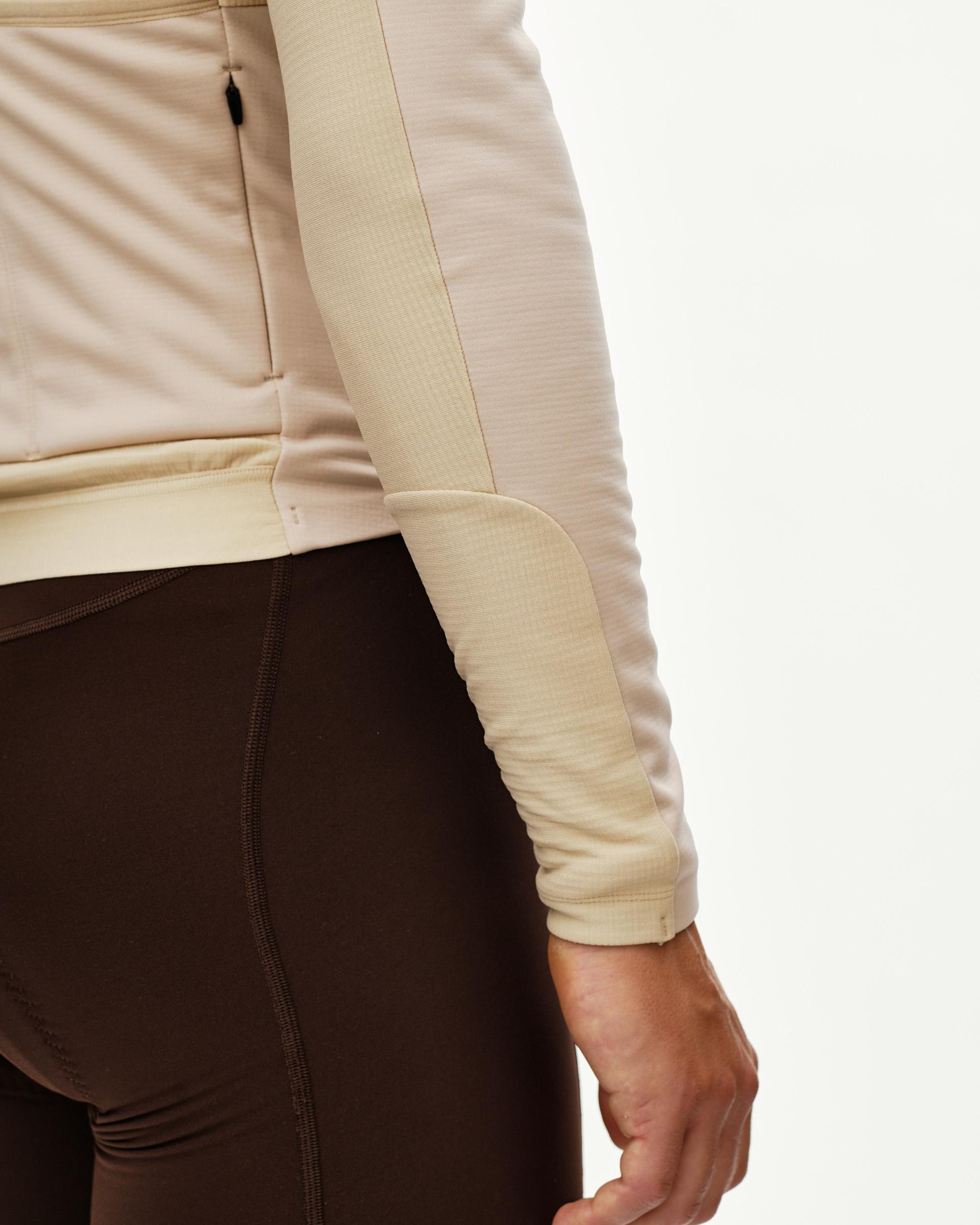 Linen Mechanism Thermal Long Sleeve cycling jersey, side detail on model with two-tone panel and ribbed cuff