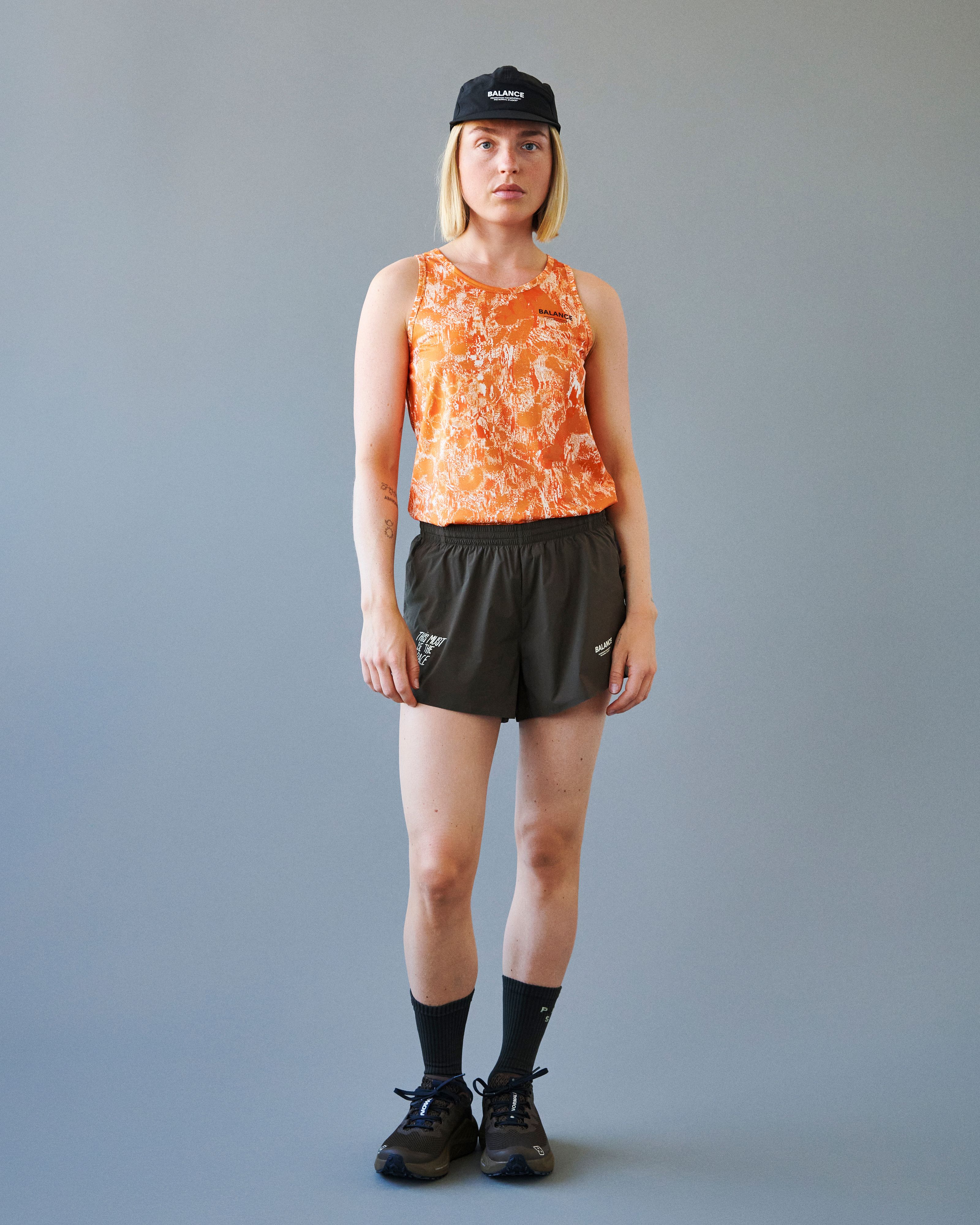Orange Balance singlet on model with white abstract print
