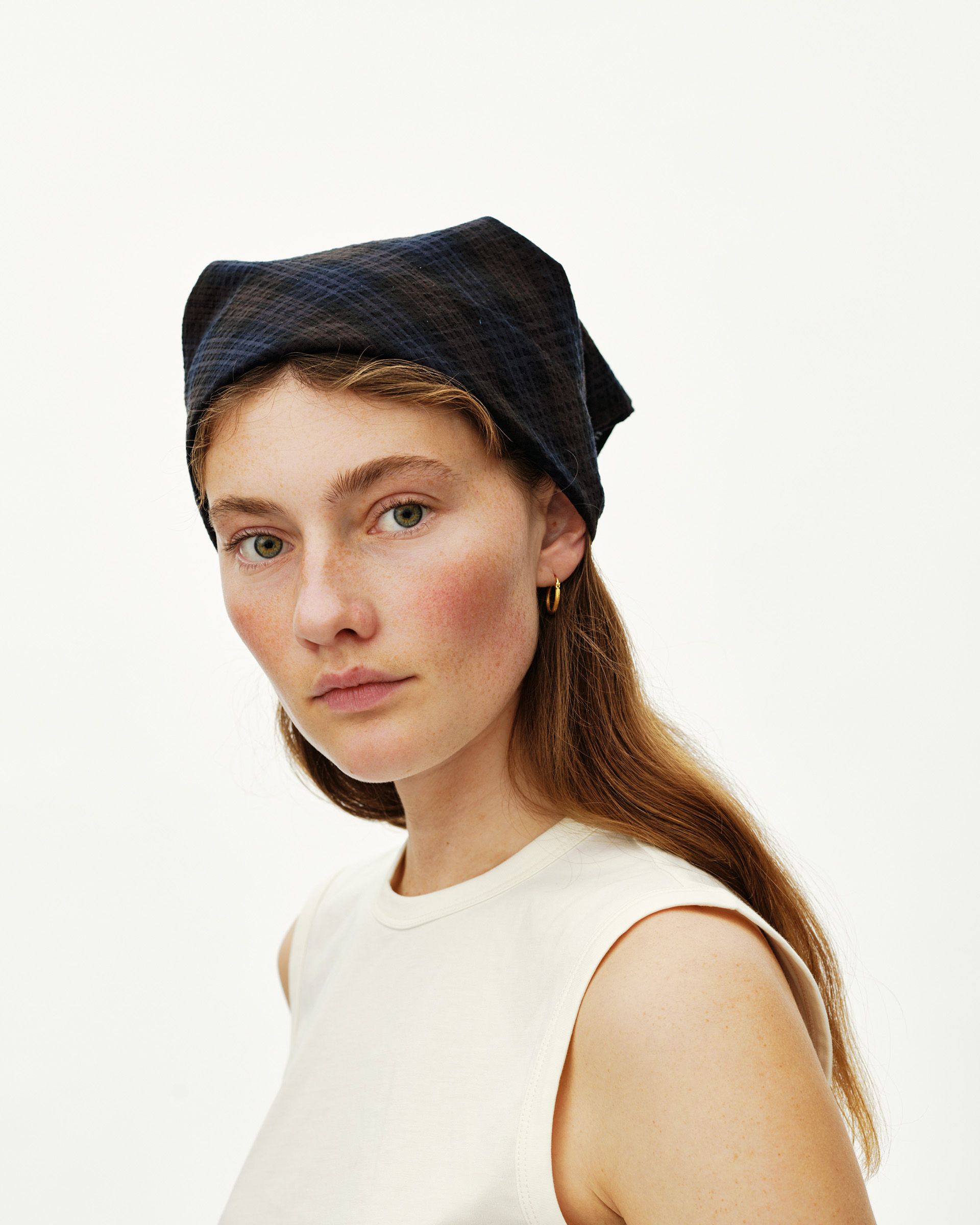 Dark Navy Off-Race Seersucker bandana on model, front view worn wrapped around head with textured check fabric