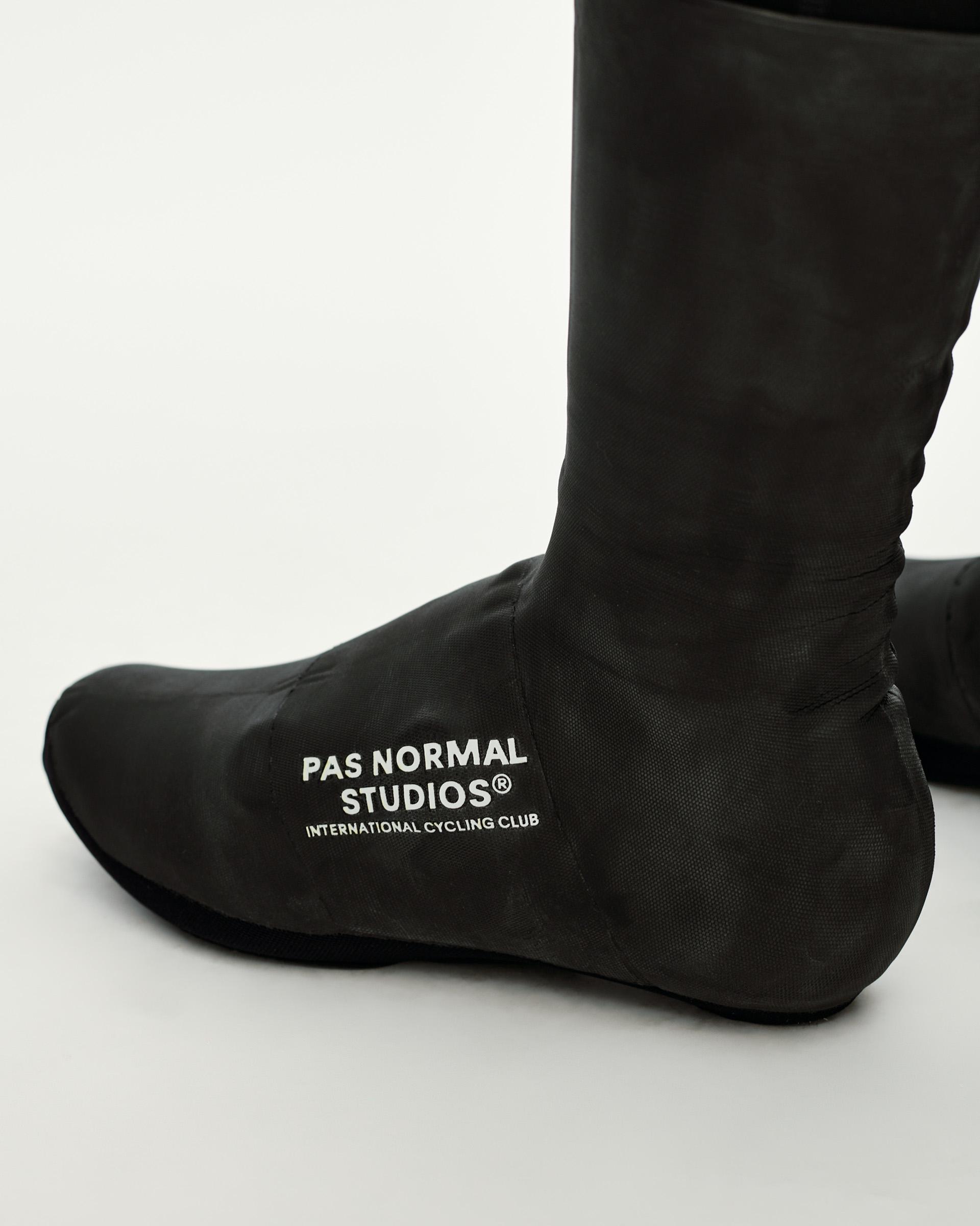 Black Logo Heavy cycling overshoes, three-quarter view on model with white chest logo print