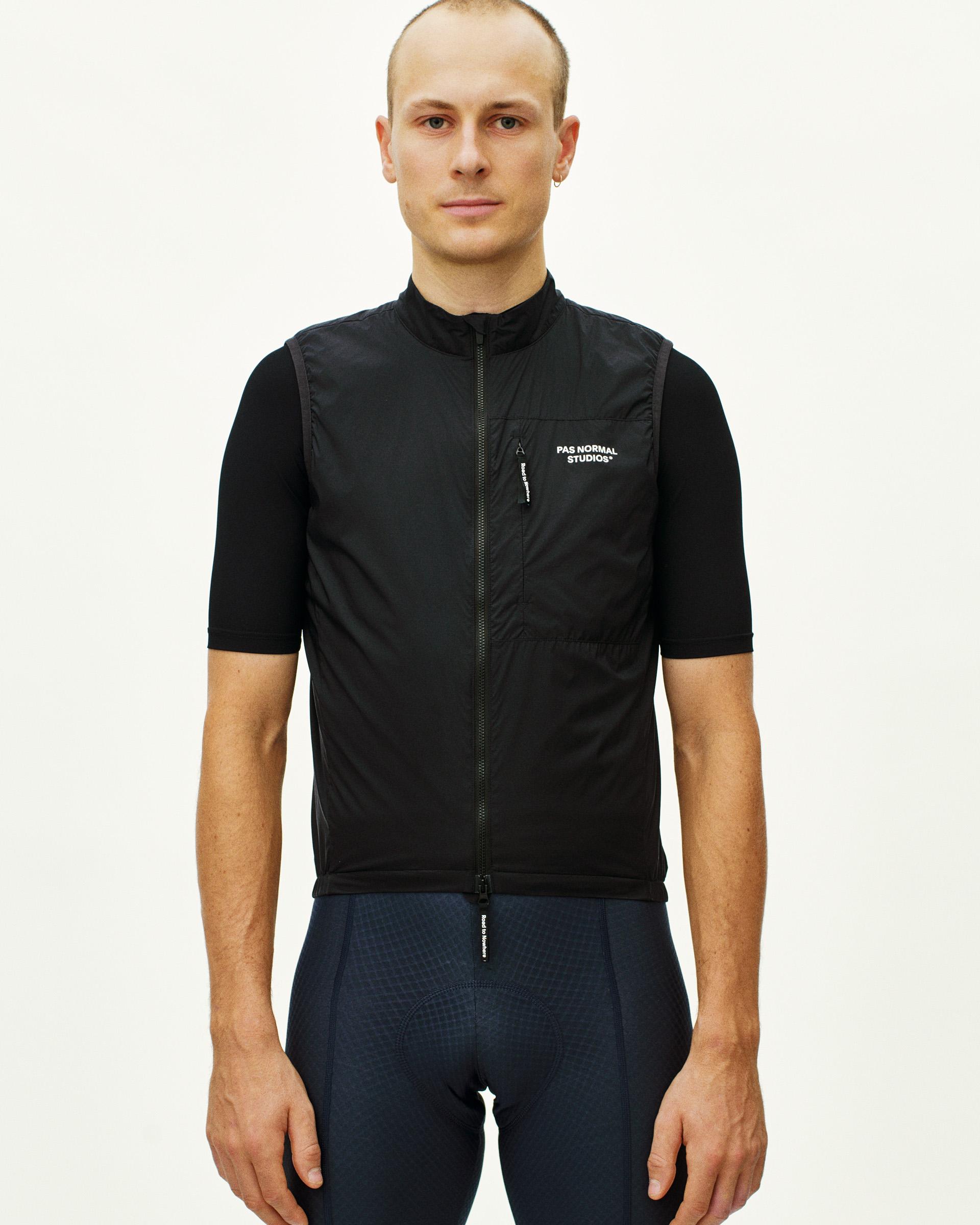 Black Essential insulated cycling gilet on model, front view with chest pocket and full zip