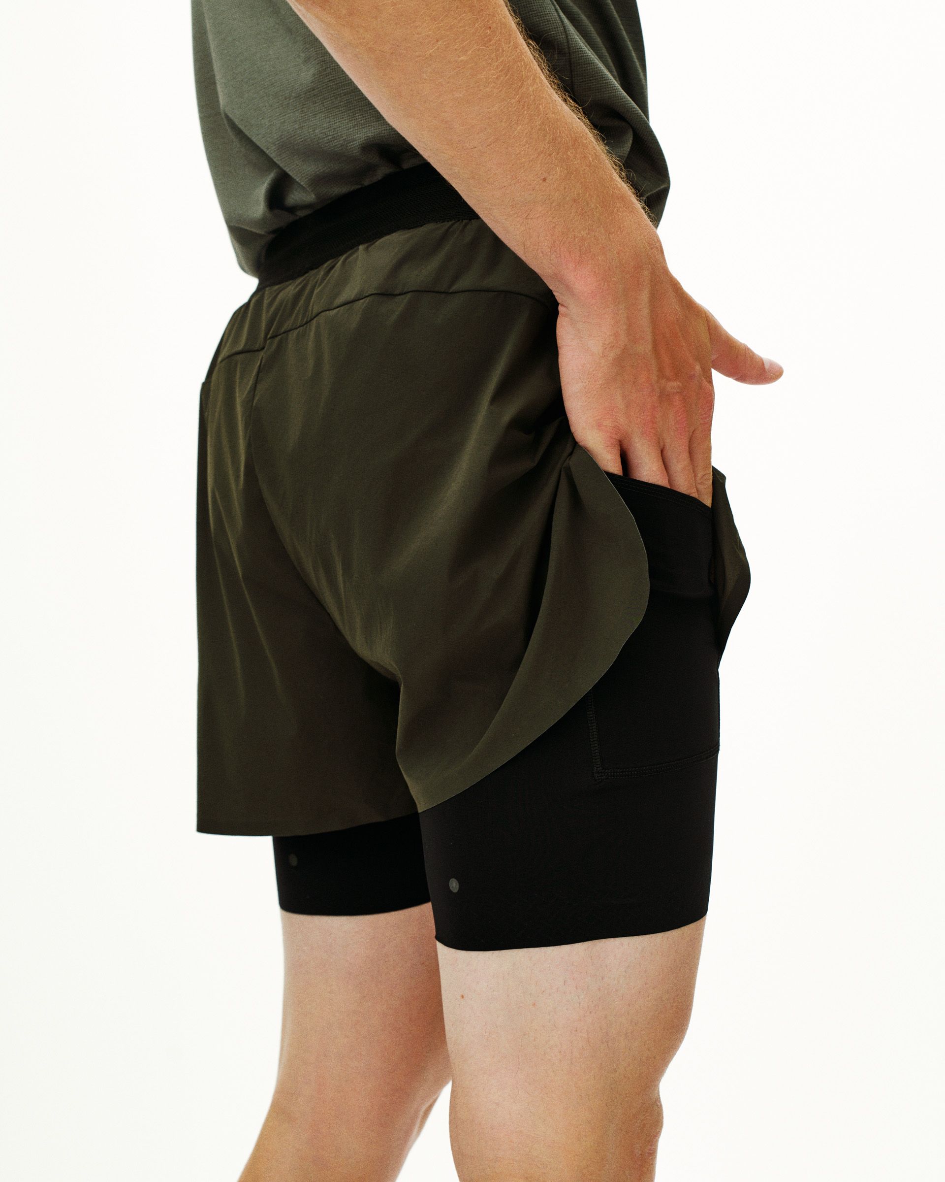 Dark Olive Balance 2-in-1 shorts on model showing outer shell and inner compression layer